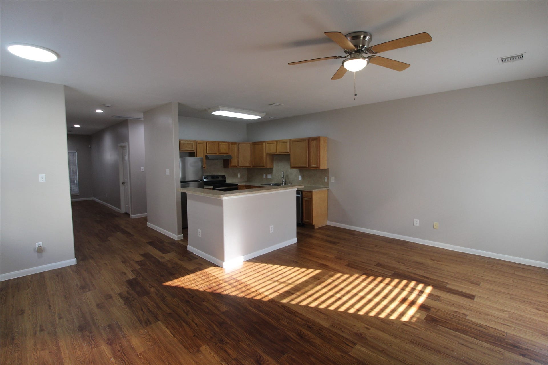 7816 Comal Street, #B, Houston, TX 77051 View of the open kitchen, family, and dining areas.
