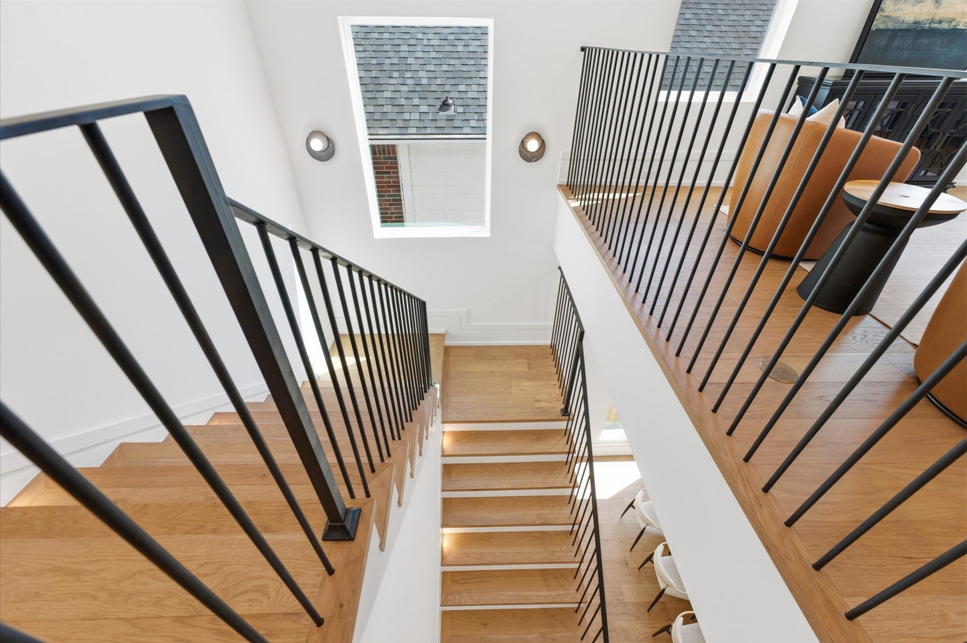 4313 Lula Street, Bellaire, TX 77401 Modern staircase featuring striking black railing and contemporary design.
