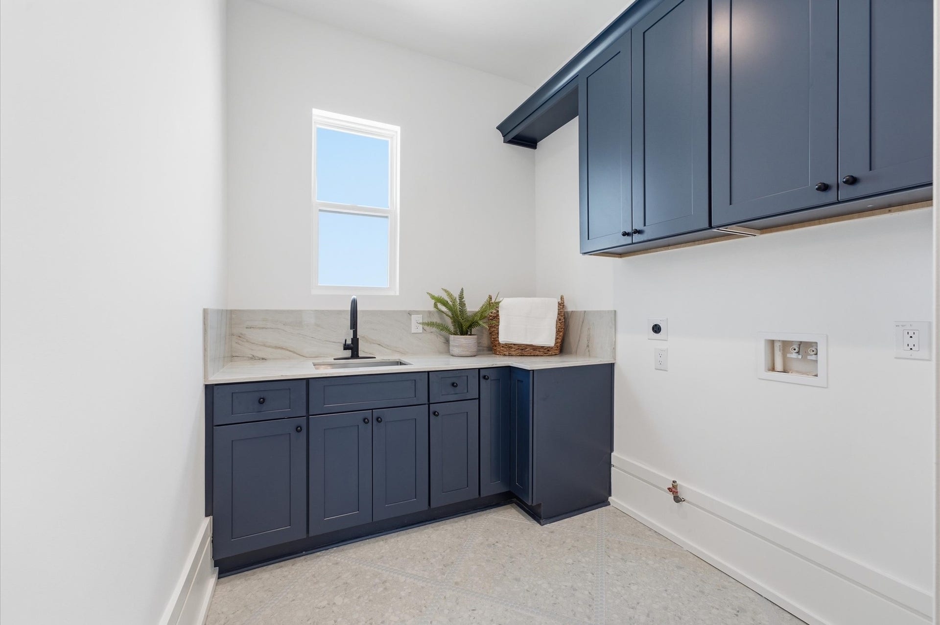 4313 Lula Street, Bellaire, TX 77401 Stylish laundry room with modern cabinetry, countertop space, and sleek finishes.
