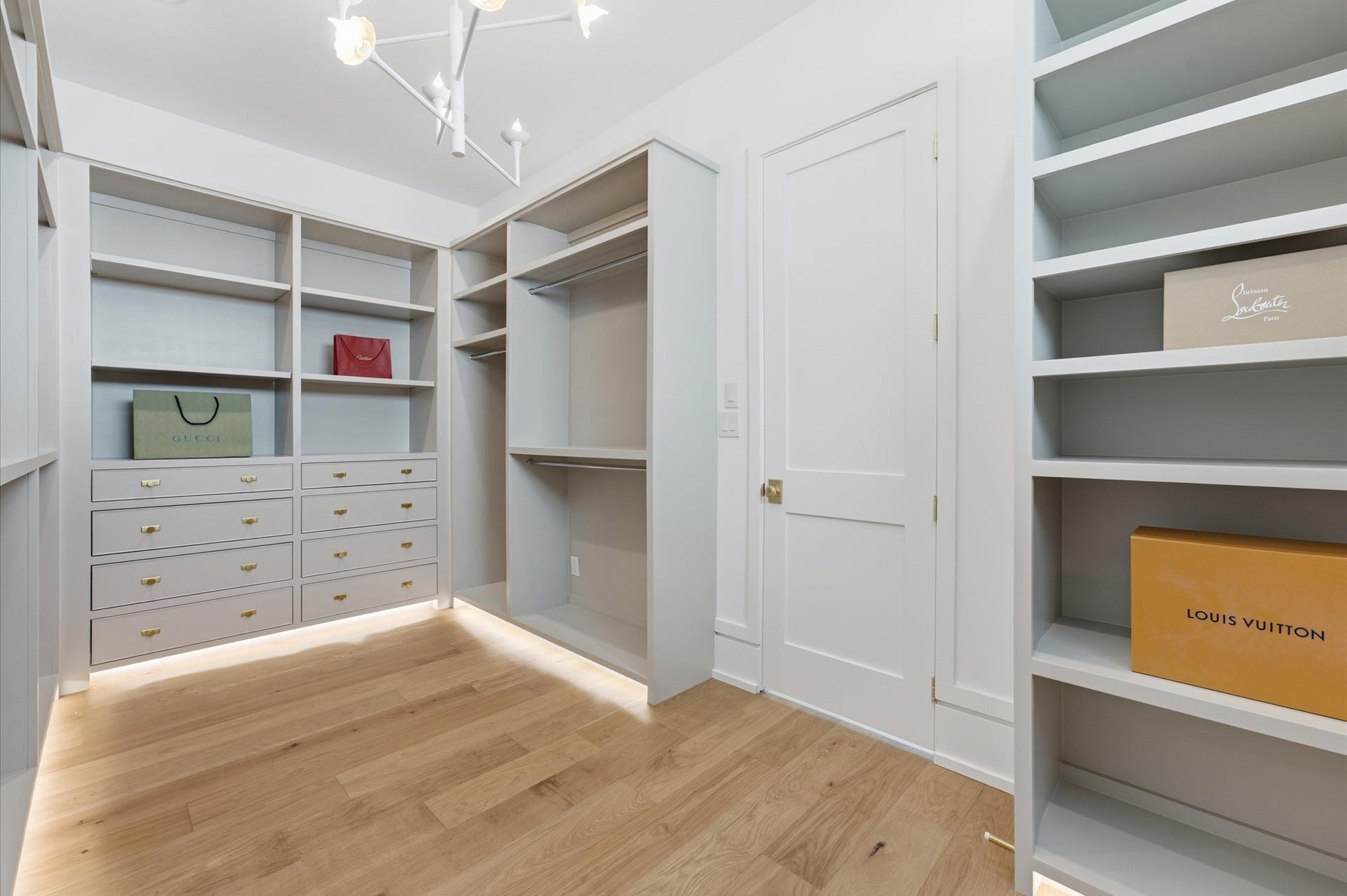 4313 Lula Street, Bellaire, TX 77401 Large walk-in closet featuring extensive built-in shelving, drawers, and hanging space.