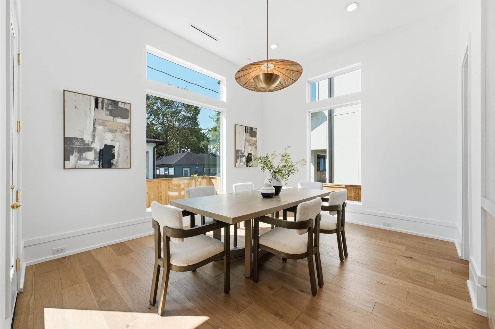 4313 Lula Street, Bellaire, TX 77401 Bright dining area with modern lighting, wood flooring, and views to the outdoors.