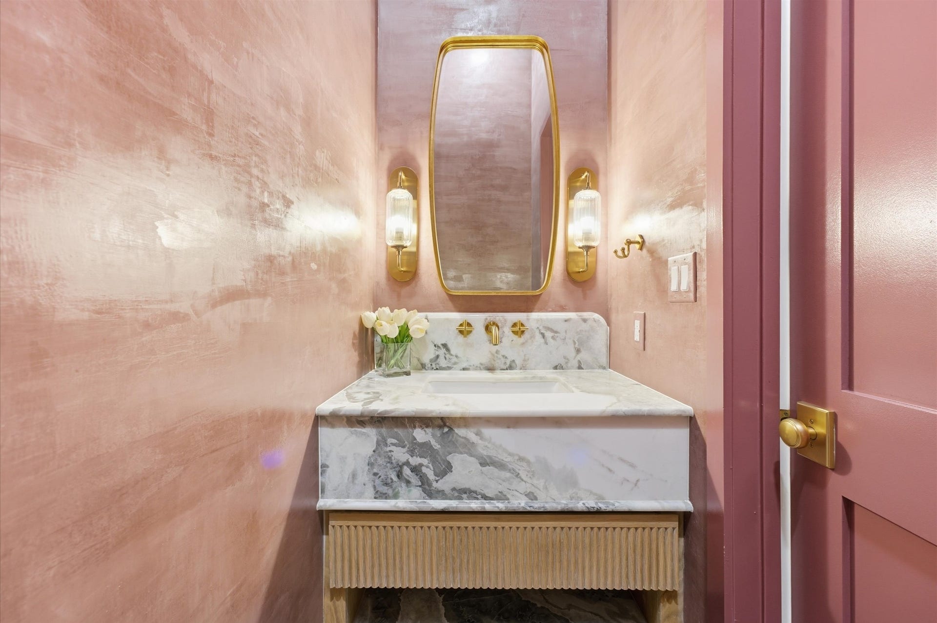4313 Lula Street, Bellaire, TX 77401 Elegant powder room featuring a stylish vanity, statement wall finish, and modern fixtures.