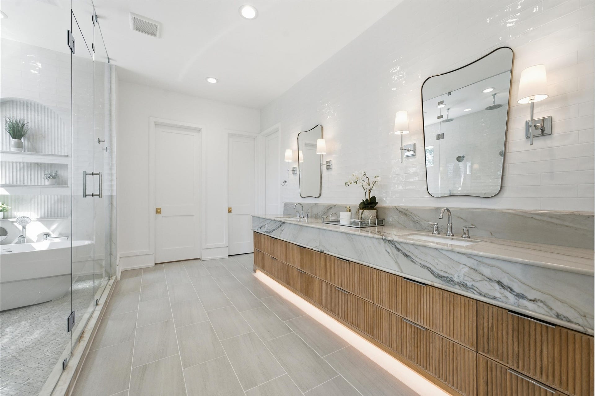 4313 Lula Street, Bellaire, TX 77401 Bright bathroom featuring a modern double vanity, soaking tub, and clean contemporary finishes.