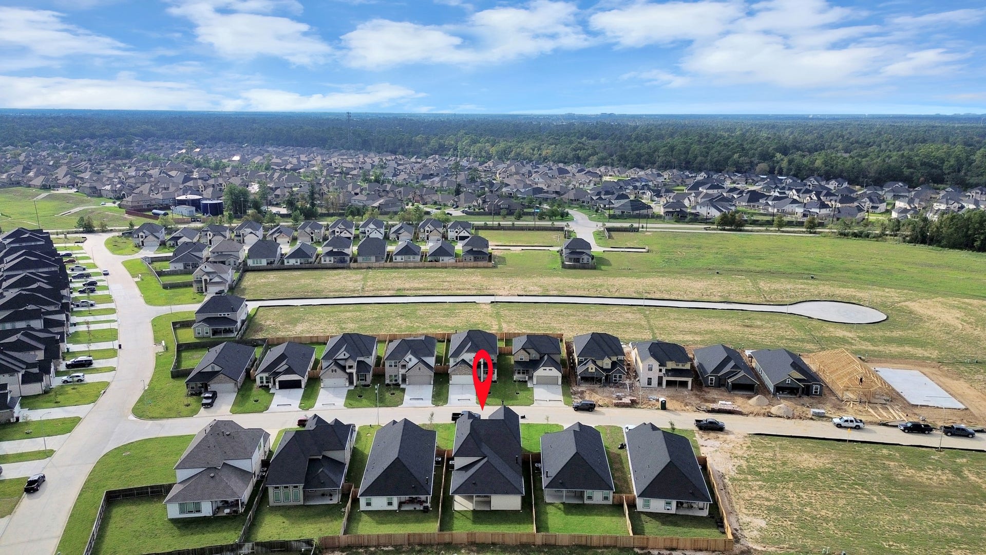 24514 Broad Park Ct, Spring, TX 77373 An aerial view of a spacious subdivision lot, highlighting a well-maintained yard and a fully fenced perimeter, offering both privacy and expansive outdoor space.
