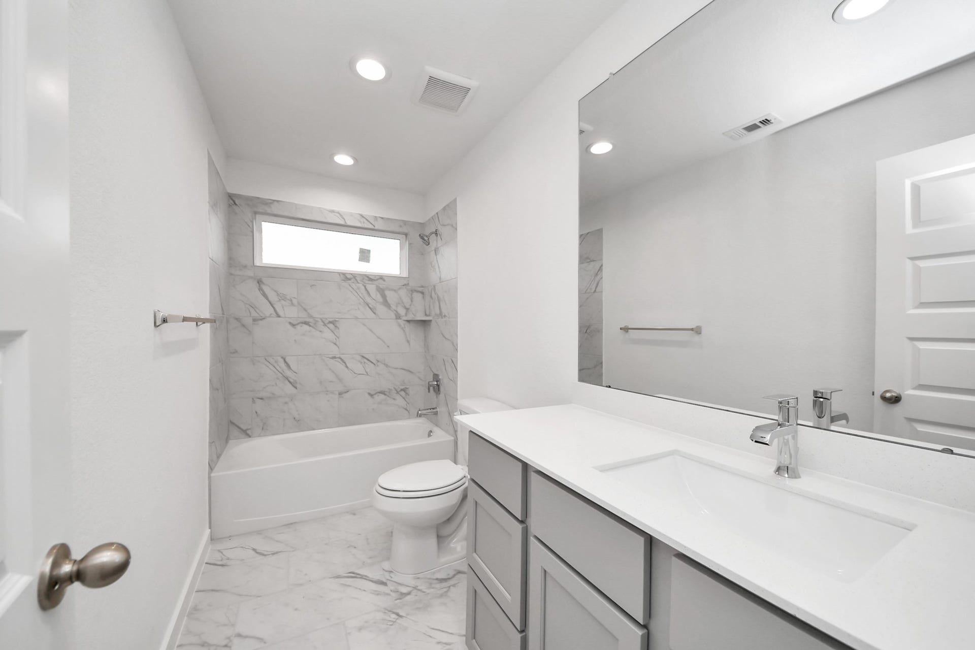 24514 Broad Park Ct, Spring, TX 77373 Secondary bath features tile flooring, bath/shower combo with tile surround, light stained wood cabinets, beautiful light countertop.