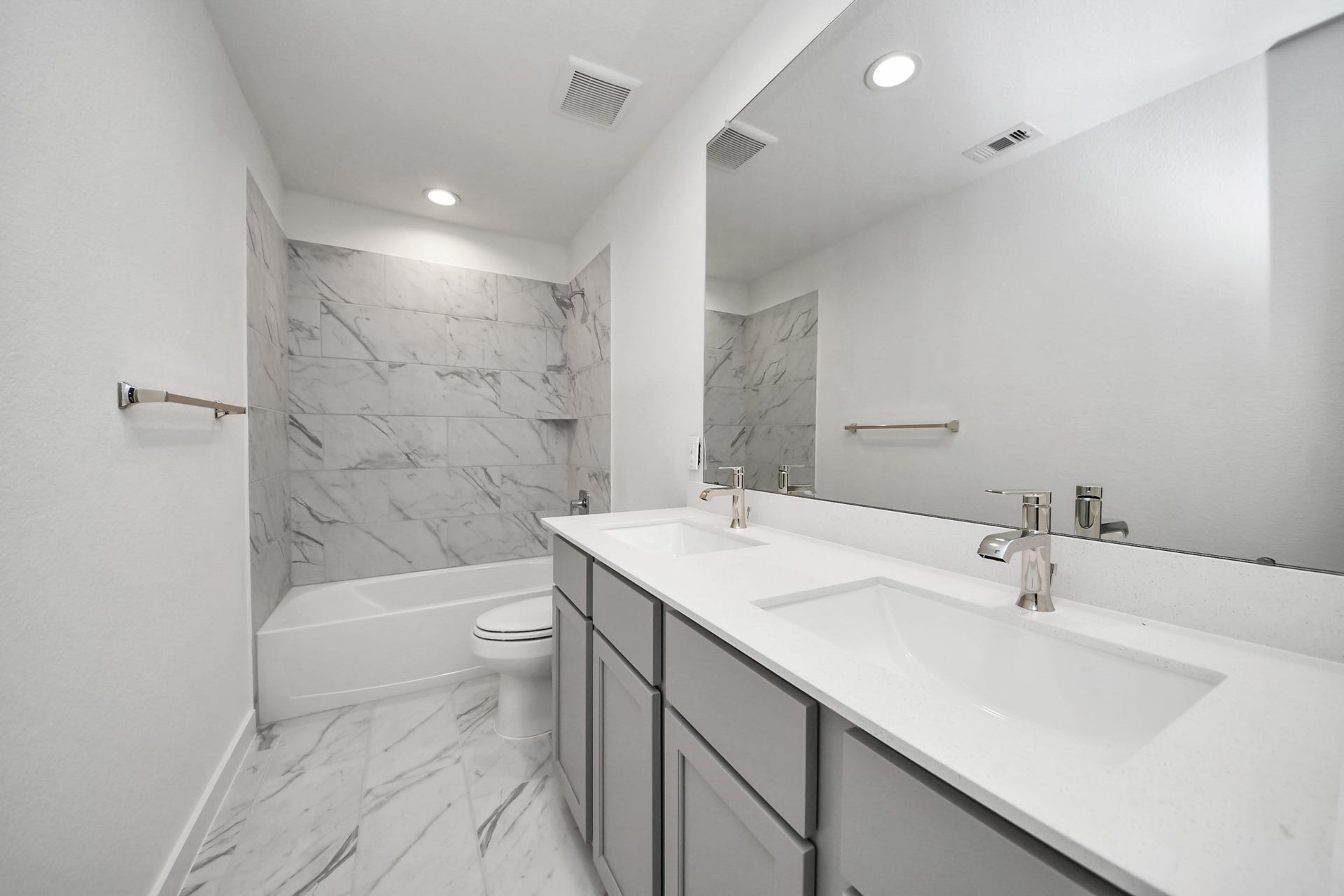 24514 Broad Park Ct, Spring, TX 77373 Secondary bath features tile flooring, bath/shower combo with tile surround, light stained wood cabinets, beautiful light countertop.