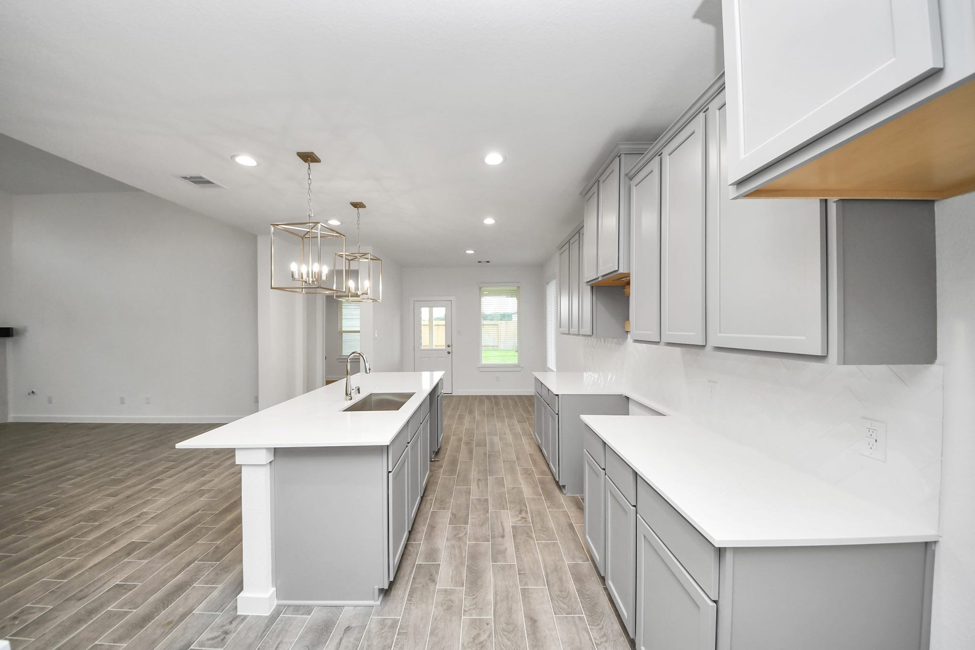 24514 Broad Park Ct, Spring, TX 77373 The extended counter area adds both practicality and style, making meal preparation a breeze. Every detail is thoughtfully designed to enhance the kitchen's functionality and aesthetic appeal.