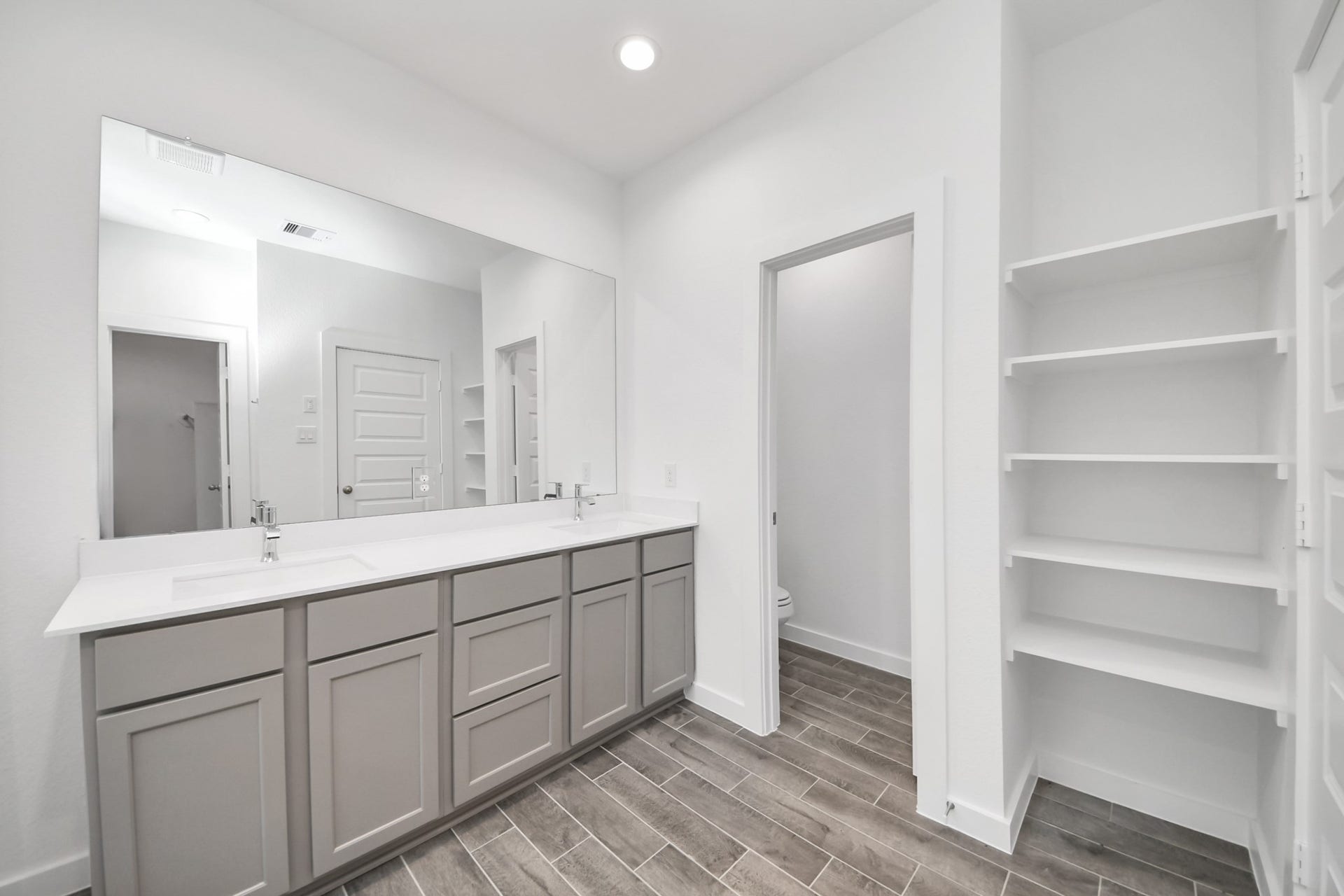 24514 Broad Park Ct, Spring, TX 77373 Elevate your daily routine at the elegant vanity, now equipped with double sinks, light countertops, modern hardware, and beautiful recessed lights.