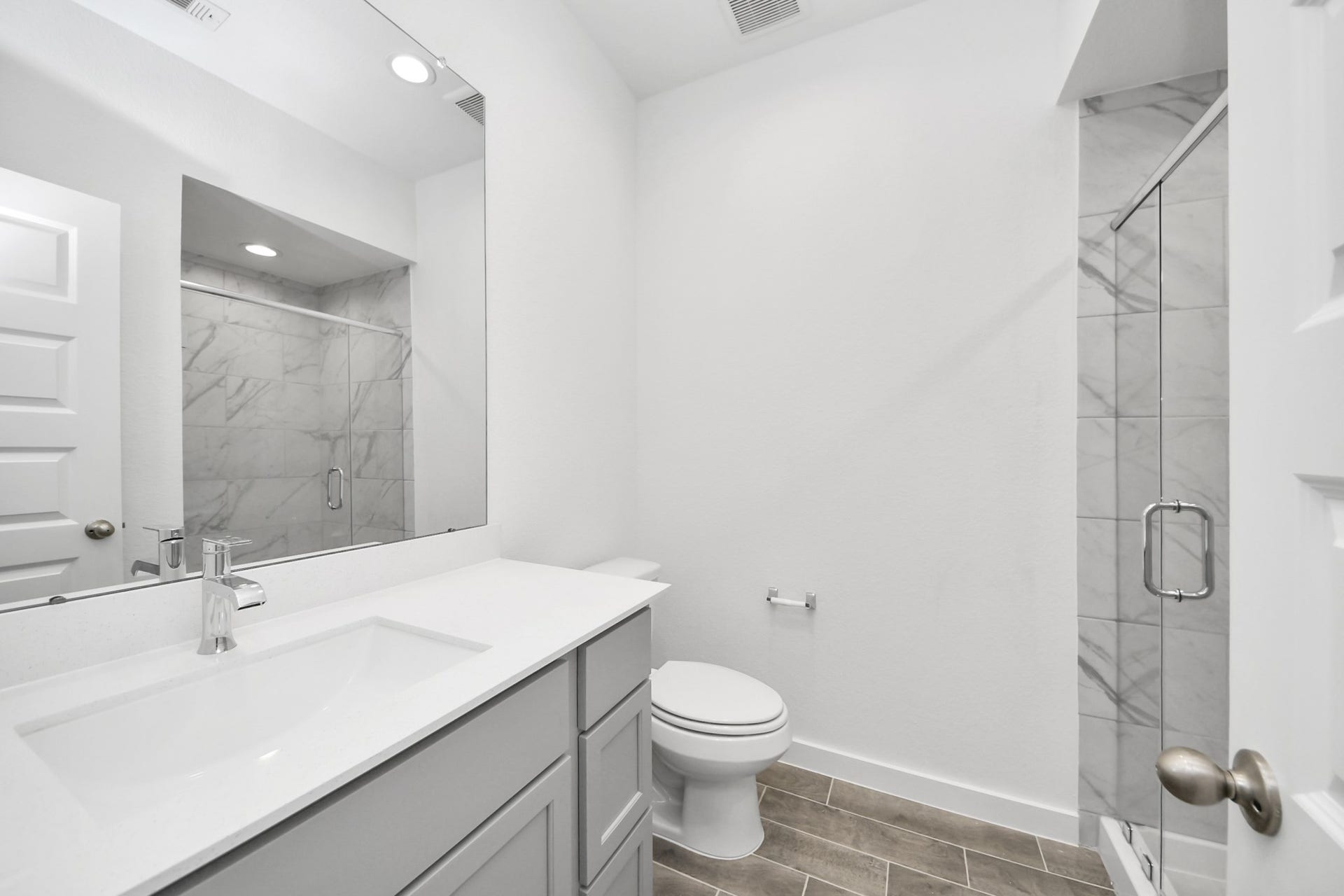24514 Broad Park Ct, Spring, TX 77373 Secondary bath features tile flooring, walk-in shower with tile surround, light stained wood cabinets, beautiful light countertop.