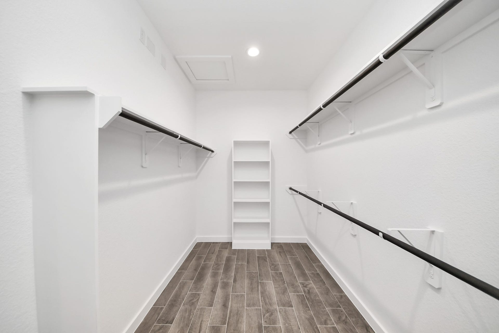 24514 Broad Park Ct, Spring, TX 77373 Walk-in closet that epitomizes luxury and practicality. This generously sized space features built-in shelving, offering abundant room for impeccable organization. High ceilings and recessed lighting create a bright and welcoming ambiance.