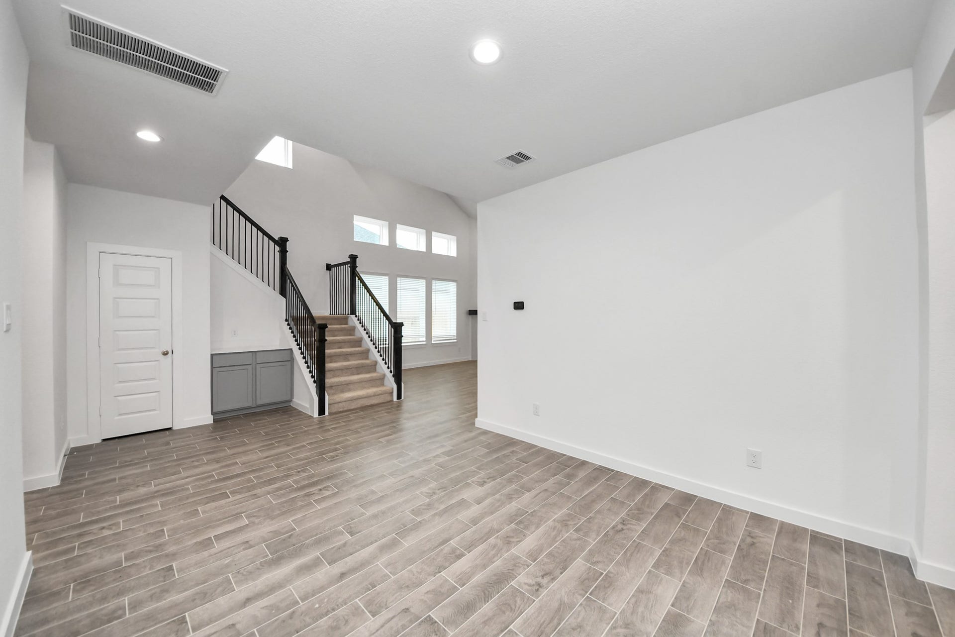 24514 Broad Park Ct, Spring, TX 77373 Create lasting memories with your family and friends at the dining table! This expansive dining room showcases sophisticated flooring, custom paint, and seamlessly connects to the family room and kitchen, providing an open and inviting atmosphere.
