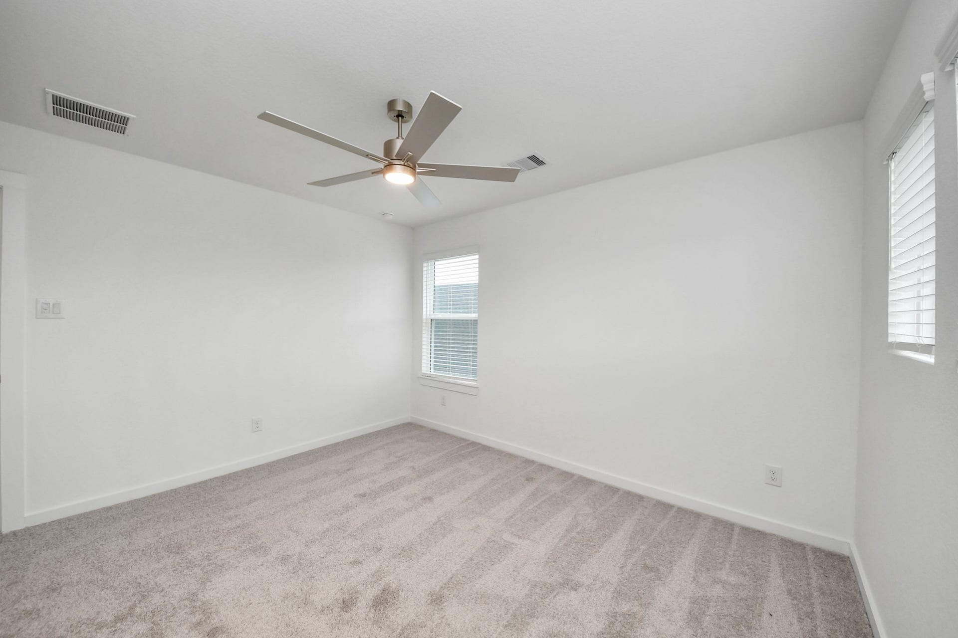 24514 Broad Park Ct, Spring, TX 77373 Secondary bedroom features plush carpeting, large windows that let in plenty of natural light, bright paint, and spacious closets.