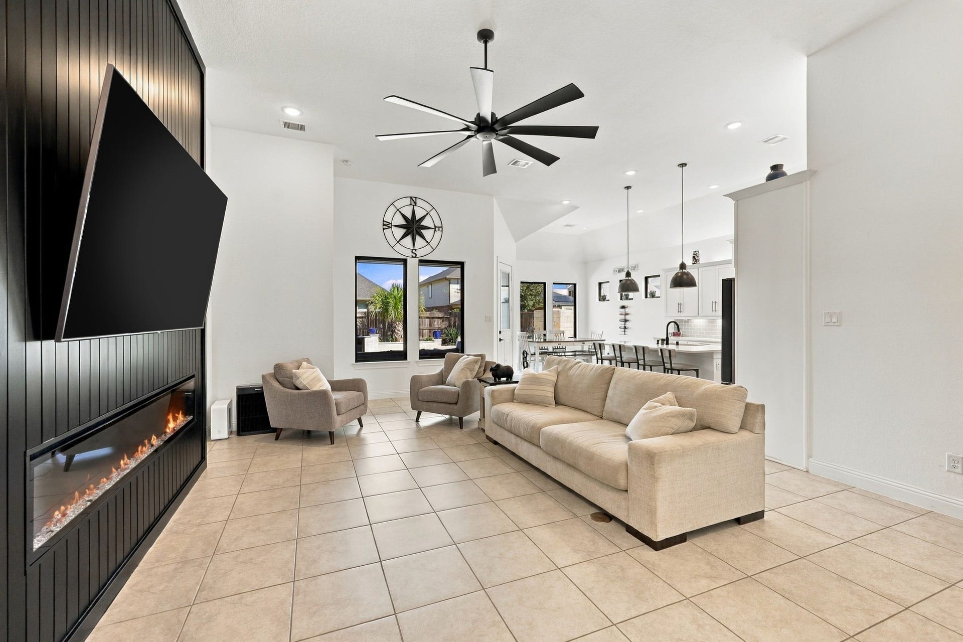 Welcome into the spacious living room, where comfort meets elegance with an impressive custom fireplace.