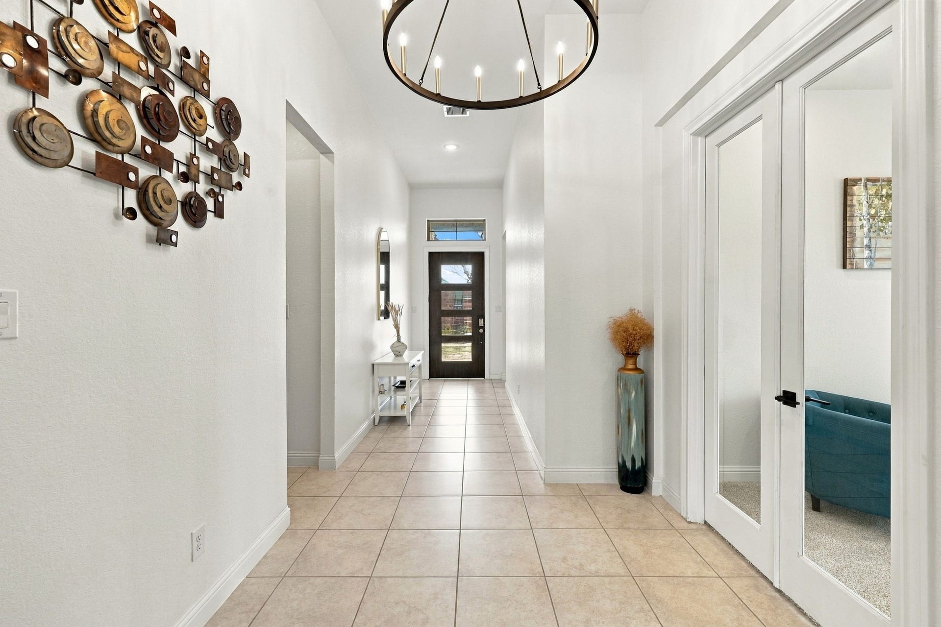 As you continue through the foyer, notice the upgraded lighting, one of several enhancements found throughout the home.