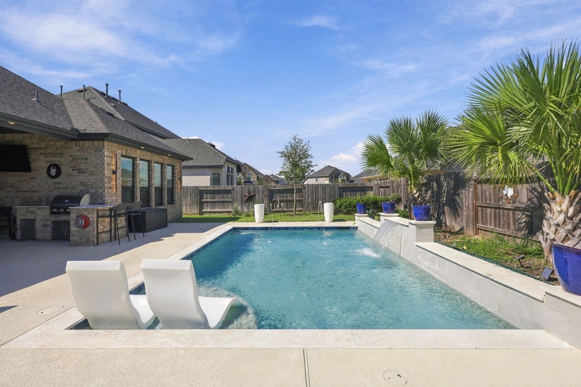 The backyard combines a refreshing pool, attractive landscaping, and outdoor living areas designed for enjoyment- why spend it somewhere else when your space can be the place to be!