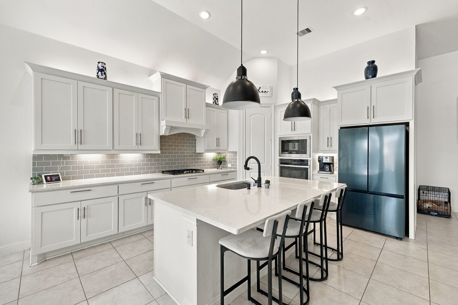 The kitchen combines beautiful white cabinetry, providing even more storage and functionality to this beautiful home.