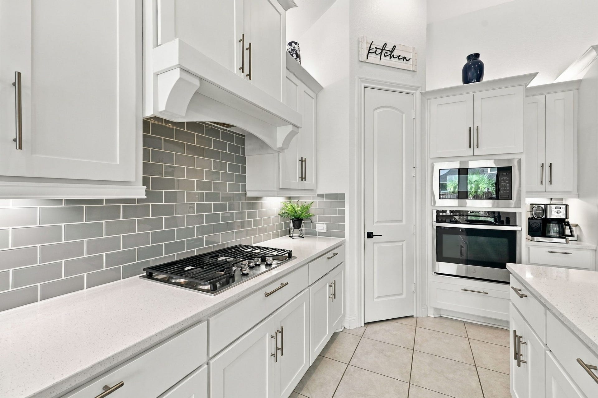 Enjoy a well-equipped kitchen featuring a gas cooktop, built-in appliances, decorative backsplash, and abundant storage.