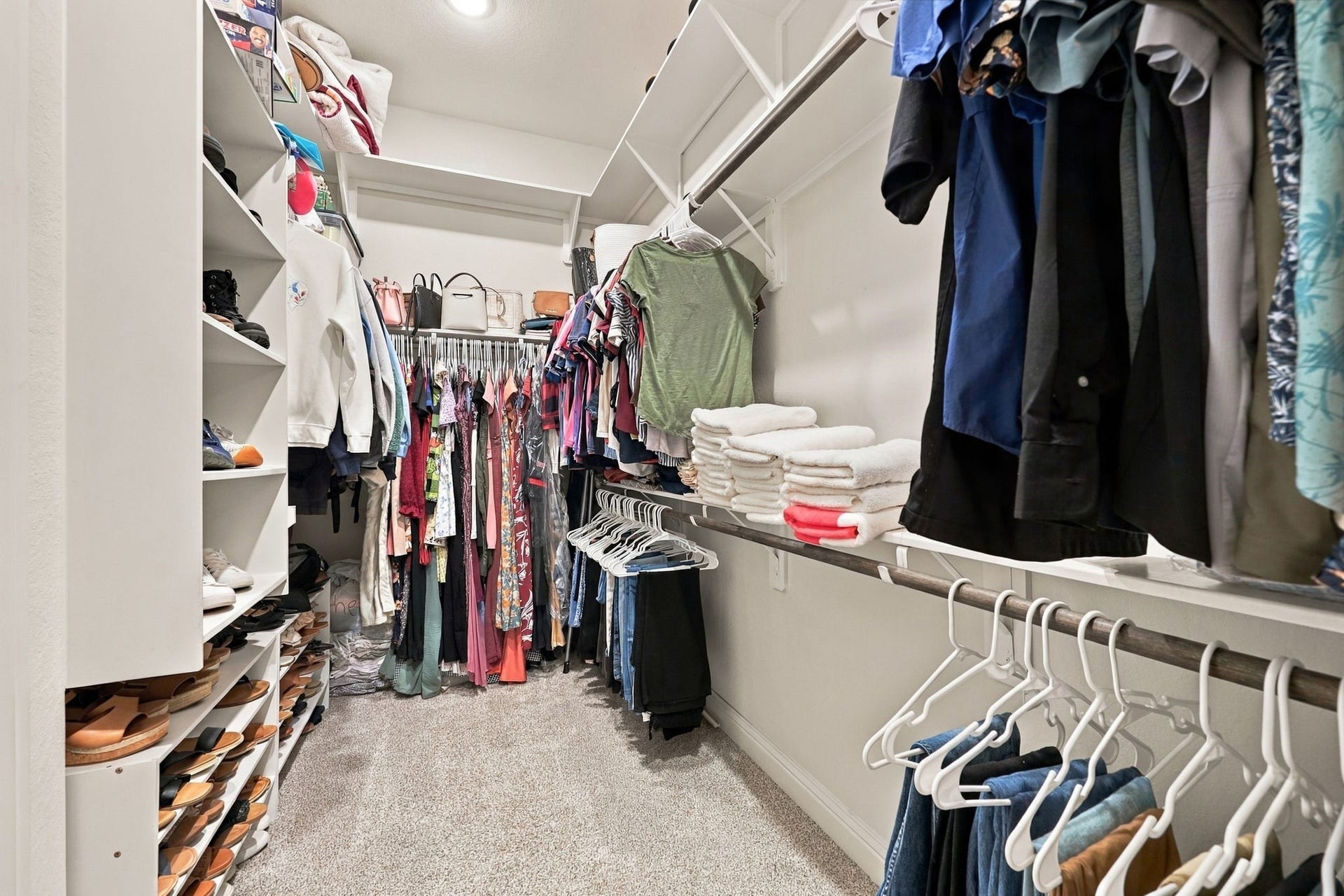 Completing the primary suite, enhanced with additional shelving for organization and storage.