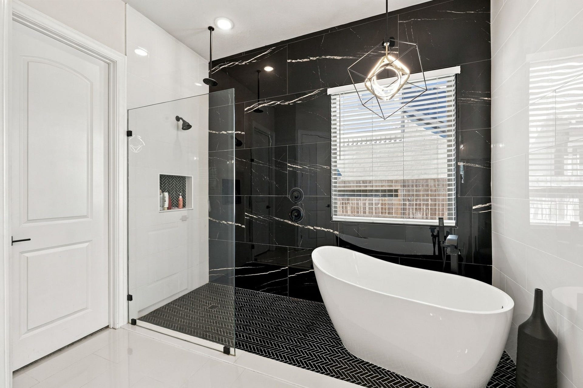 One of the home's standout upgrades!  The primary bathroom has been transformed with an oversized walk-in shower and freestanding soaking tub.