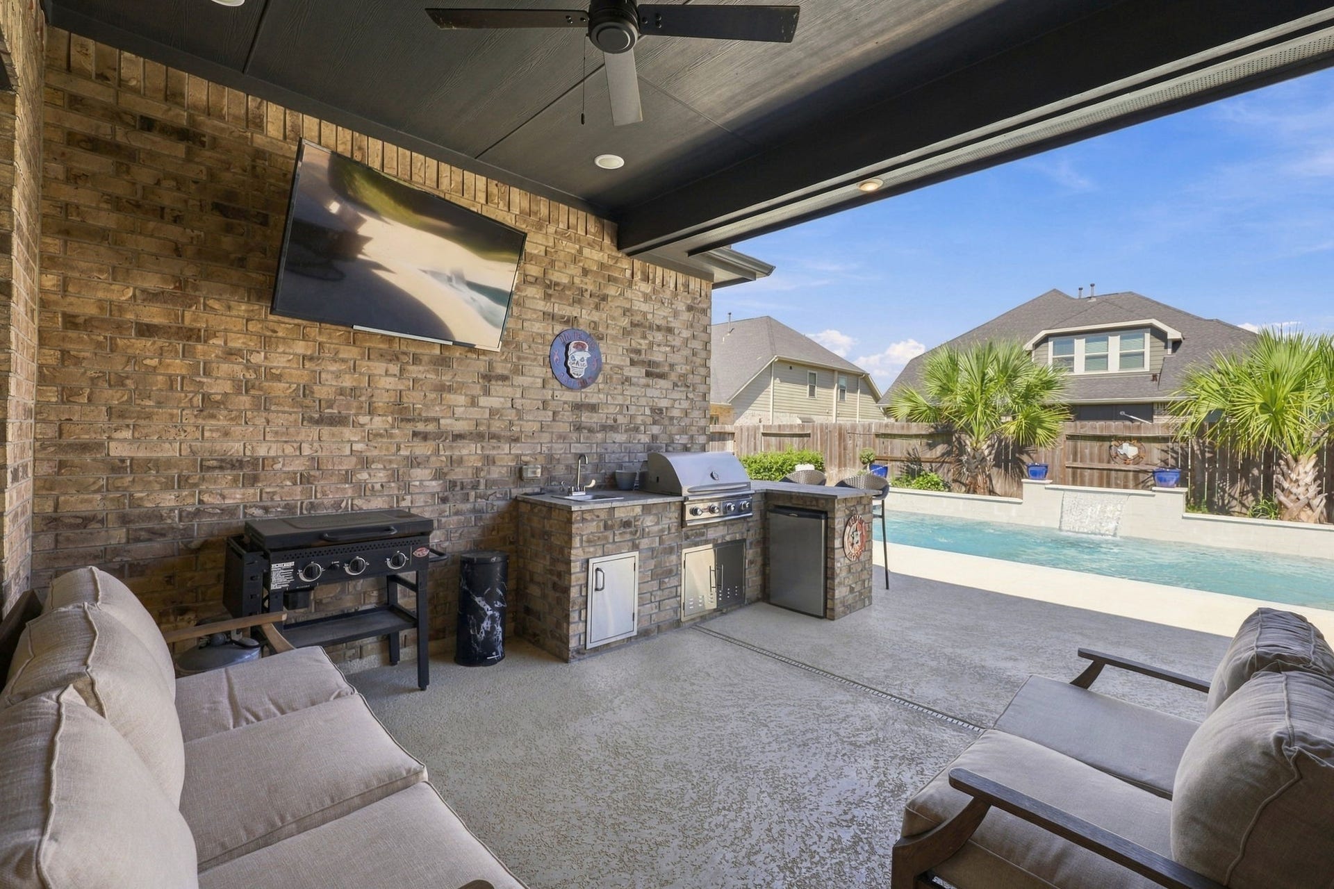 Now for one of the home's most exciting features! Step outside to discover the beautiful covered outdoor kitchen.