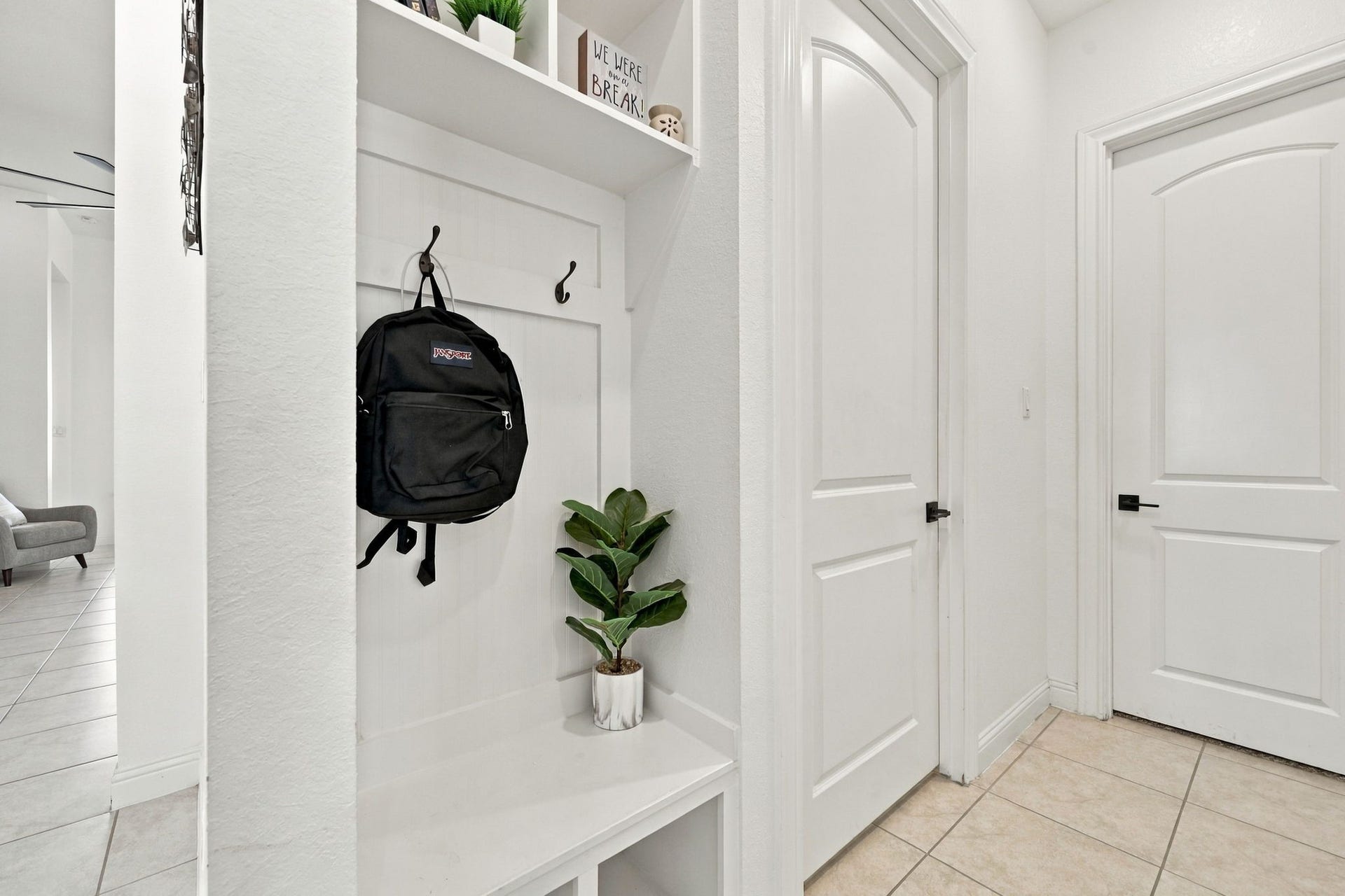 As we continue, you'll find a convenient added mud space area featuring built-in storage to help keep everyday essentials organized.