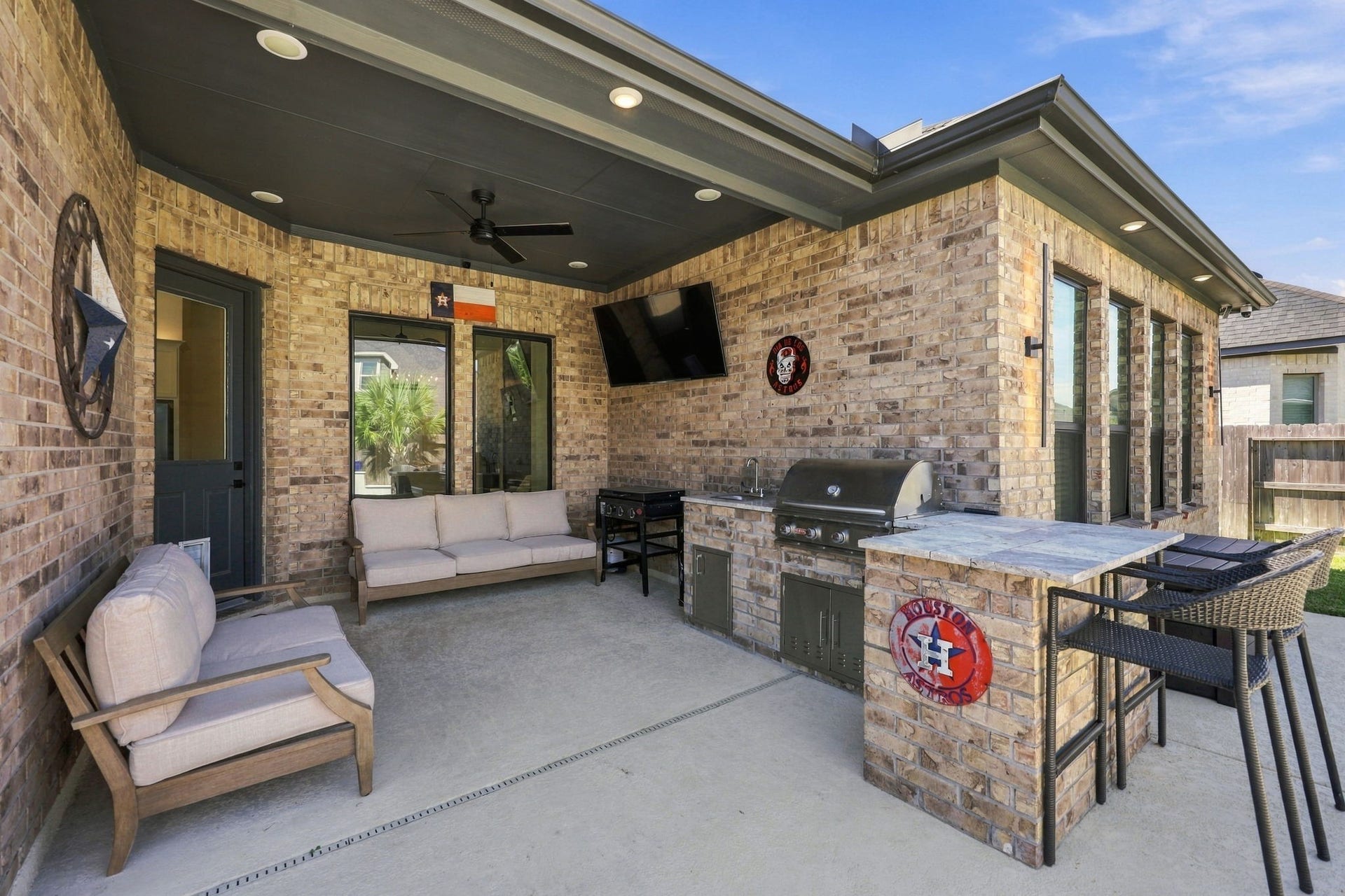 This inviting outdoor entertaining area offers a built-in grill, beautiful finishes, and a space to enjoy gatherings with friends and family.