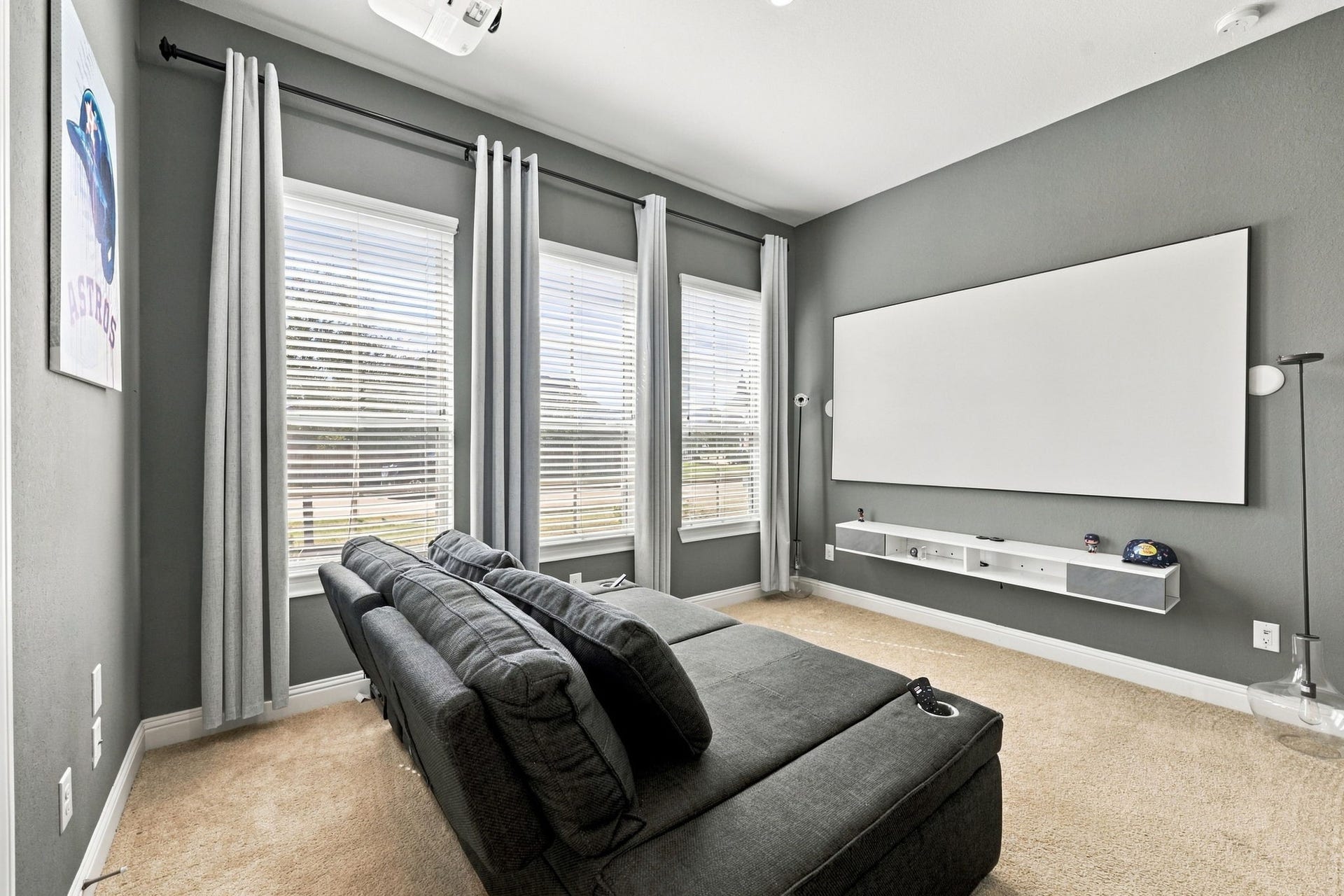 The fourth bedroom is currently enjoyed as a media room, showcasing the flexibility to create your own entertainment space or bedroom.