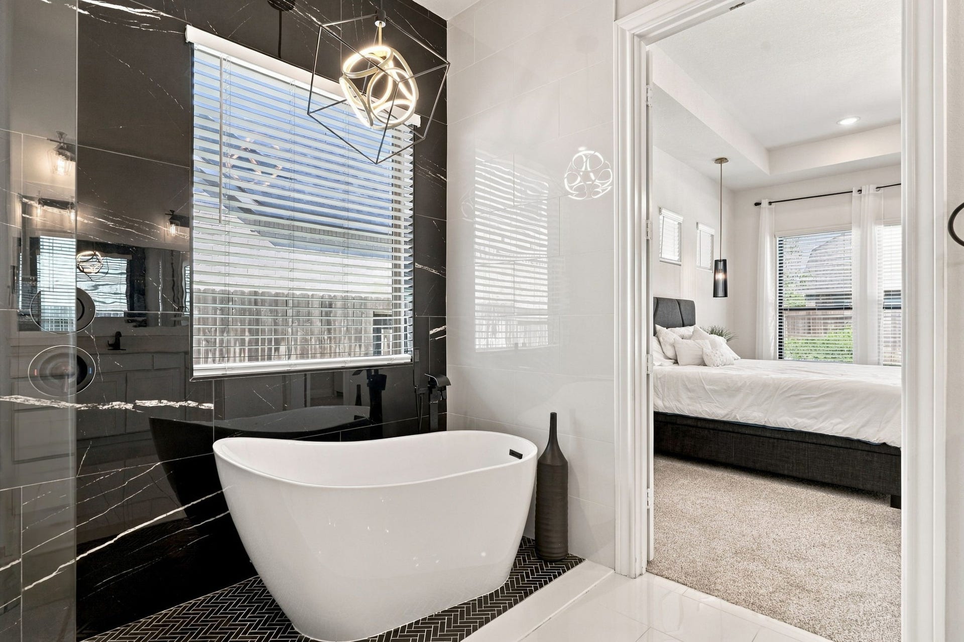 Take another look at this beautiful bathroom, where the glass-enclosed shower and freestanding tub create a relaxing retreat.