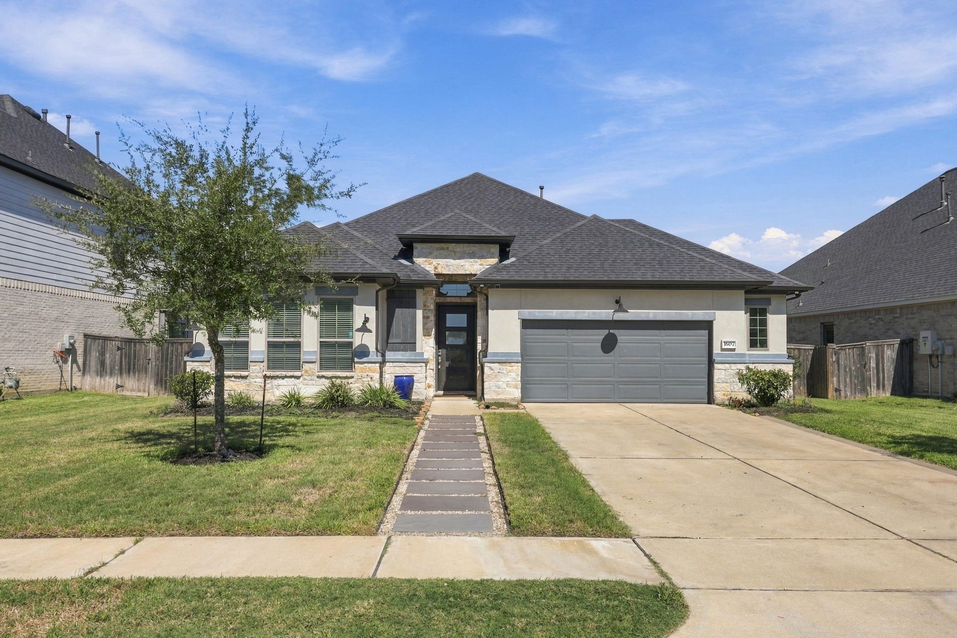 The exterior has been enhanced with updated walkways and an added sprinkler system for convenient lawn maintenance.