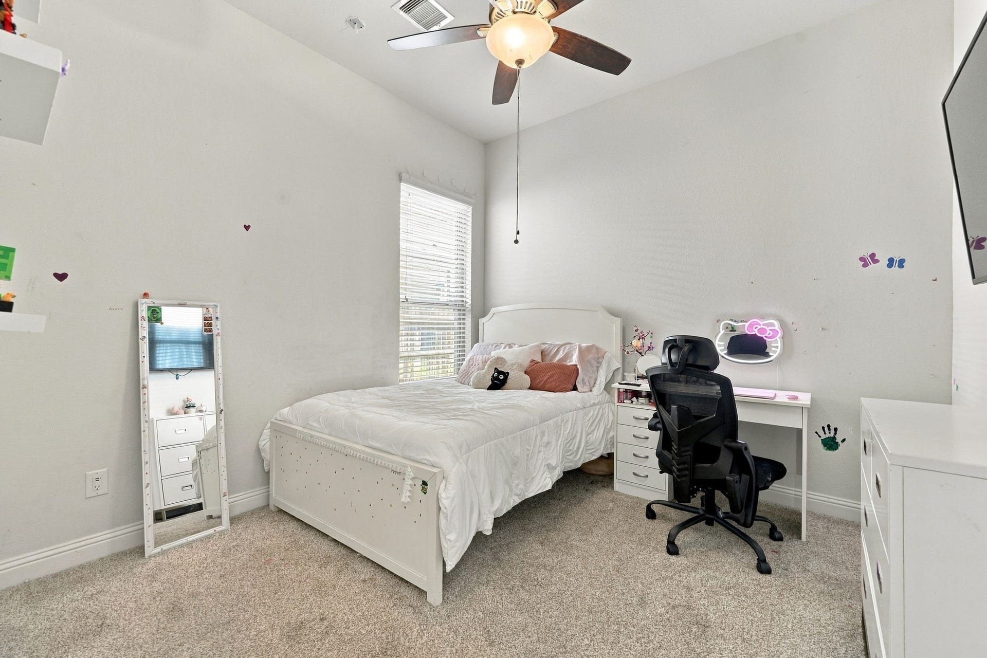 The next secondary bedroom provides a bright, welcoming space with flexibility for family or guests.