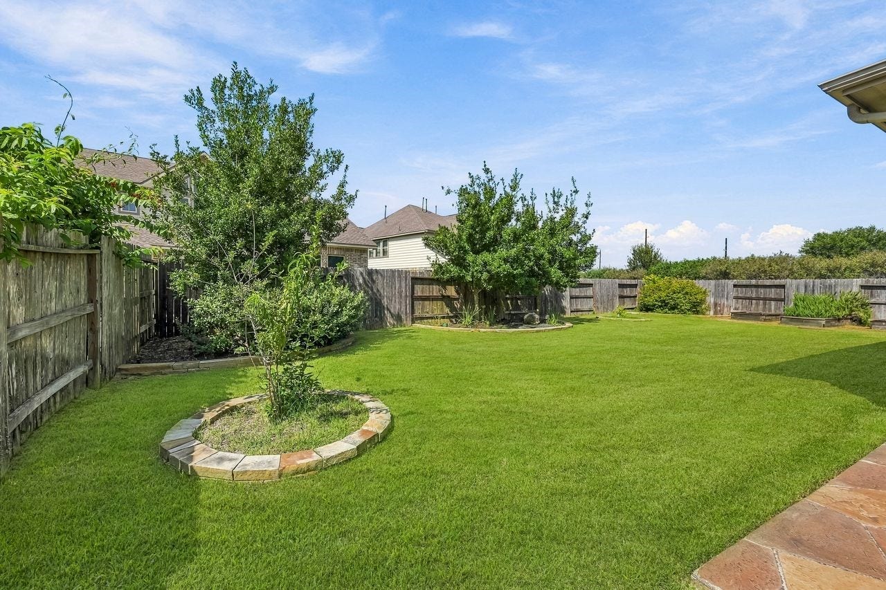 2215 Hermina Radler Drive, Richmond, TX 77469 Expansive outdoor space perfectly suited for hosting and sophisticated entertaining.
