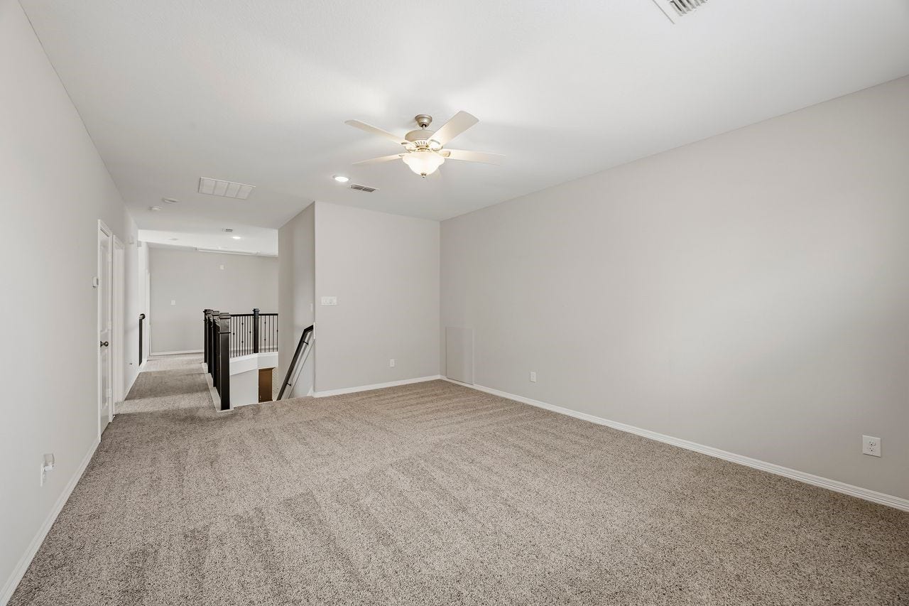 2215 Hermina Radler Drive, Richmond, TX 77469 Ascend to the second floor to find an expansive game room designed for versatility. A sleek catwalk connects the space to three secondary bedrooms, including a private guest suite with a full bath and two additional bedrooms joined by a well-appointed Jack-and-Jill bathroom featuring separate vanities.