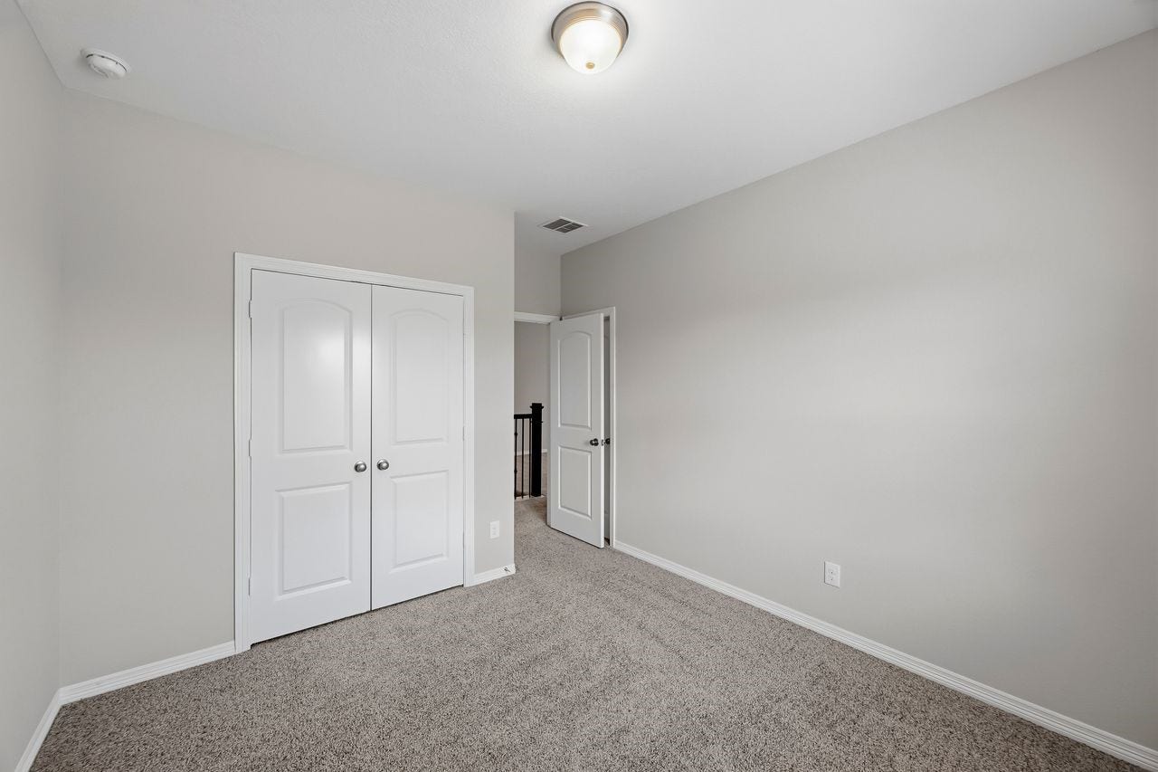 2215 Hermina Radler Drive, Richmond, TX 77469 An alternate perspective of the guest suite, highlighting the streamlined entry and integrated closet storage.