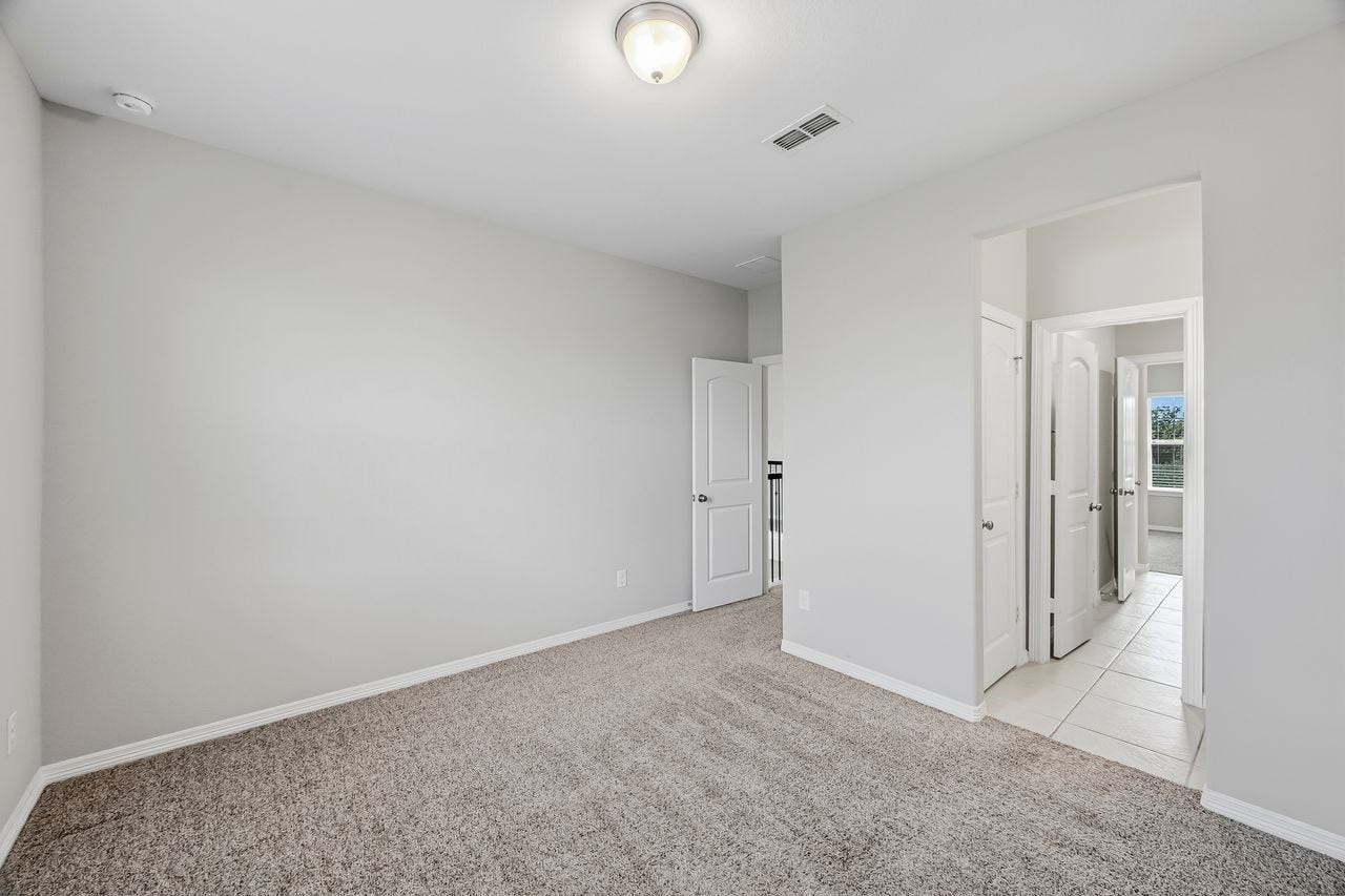 2215 Hermina Radler Drive, Richmond, TX 77469 Two secondary bedrooms connected by a refined ensuite, featuring individual vanities and a seamless layout.