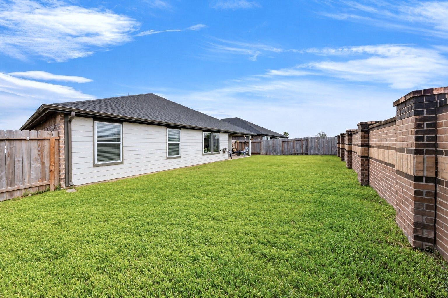 31207 Kenswick Grove Lane, Fulshear, TX 77441 Enjoy added privacy in the backyard with a brick rear fence, creating a defined outdoor space to relax and unwind.
