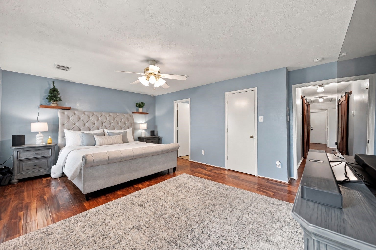 Additional view of the primary suite showcases its generous proportions and convenient connection to the rest of the home.