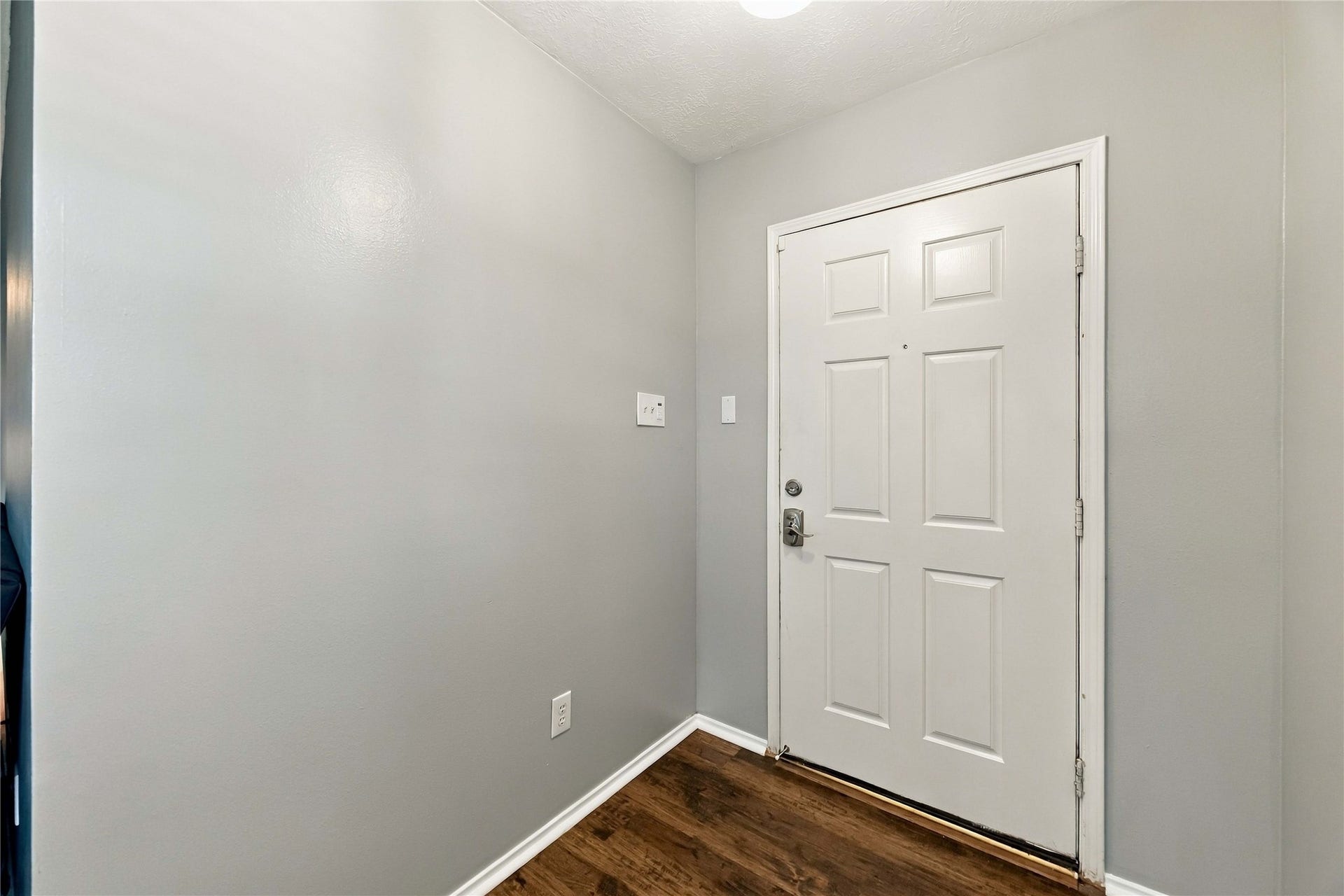 Bright entryway with wood-look flooring and a clean, neutral interior palette.