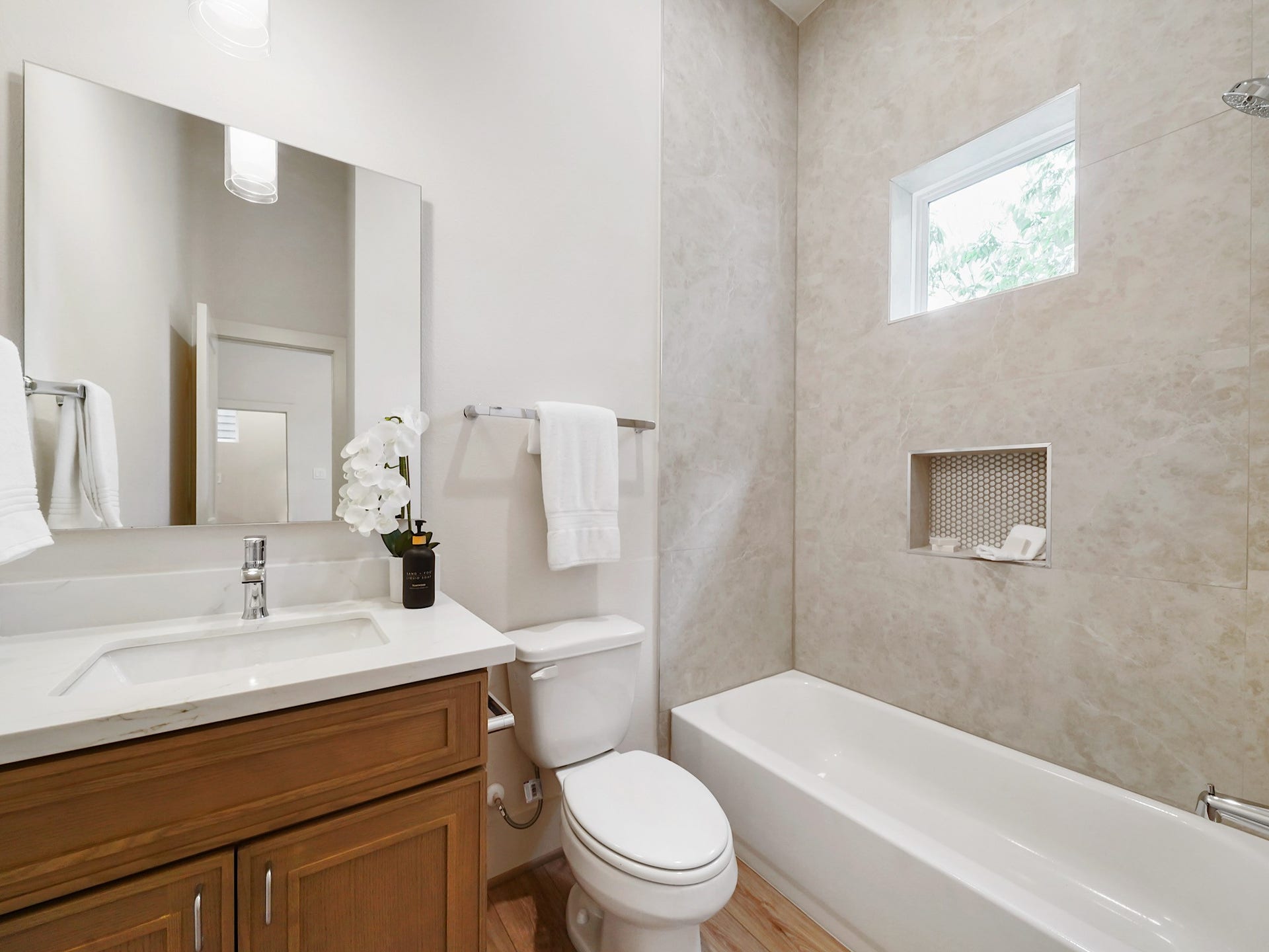Discover a stylish second bathroom featuring sleek fixtures, a chic vanity, and a bright, inviting atmosphere perfect for guests or family.