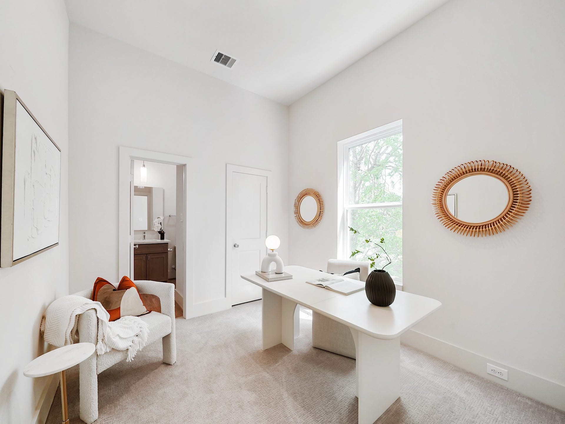 This inviting third bedroom, currently styled as a bright, airy office, offers versatility and potential for your ideal living space.
