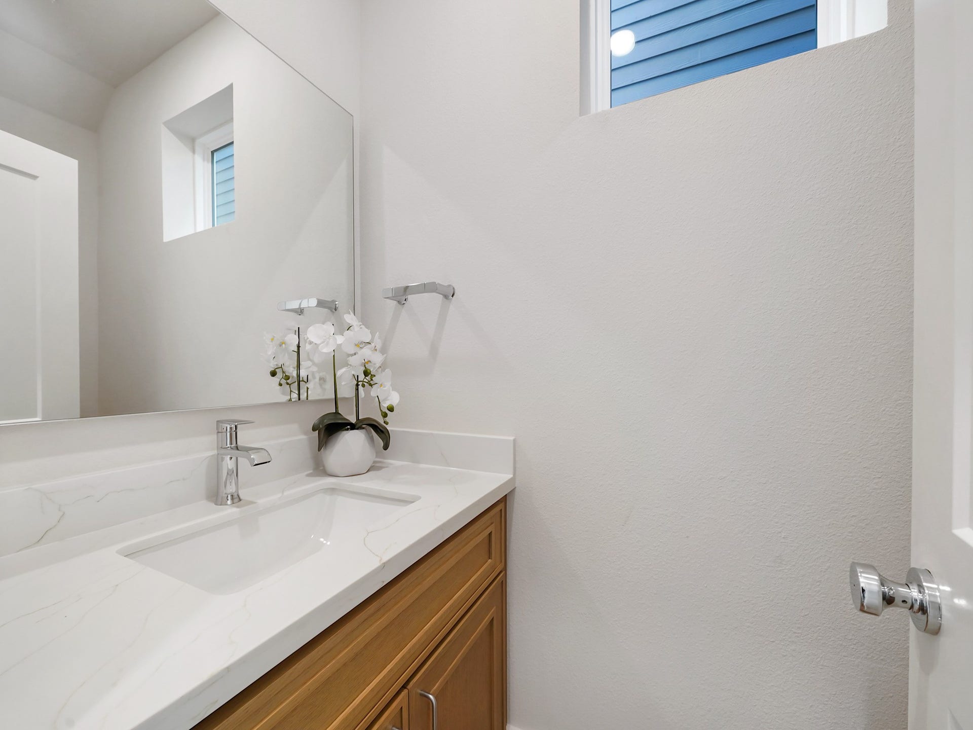 Discover the convenience and style of a beautifully appointed half bath on the first level, perfect for guests.
