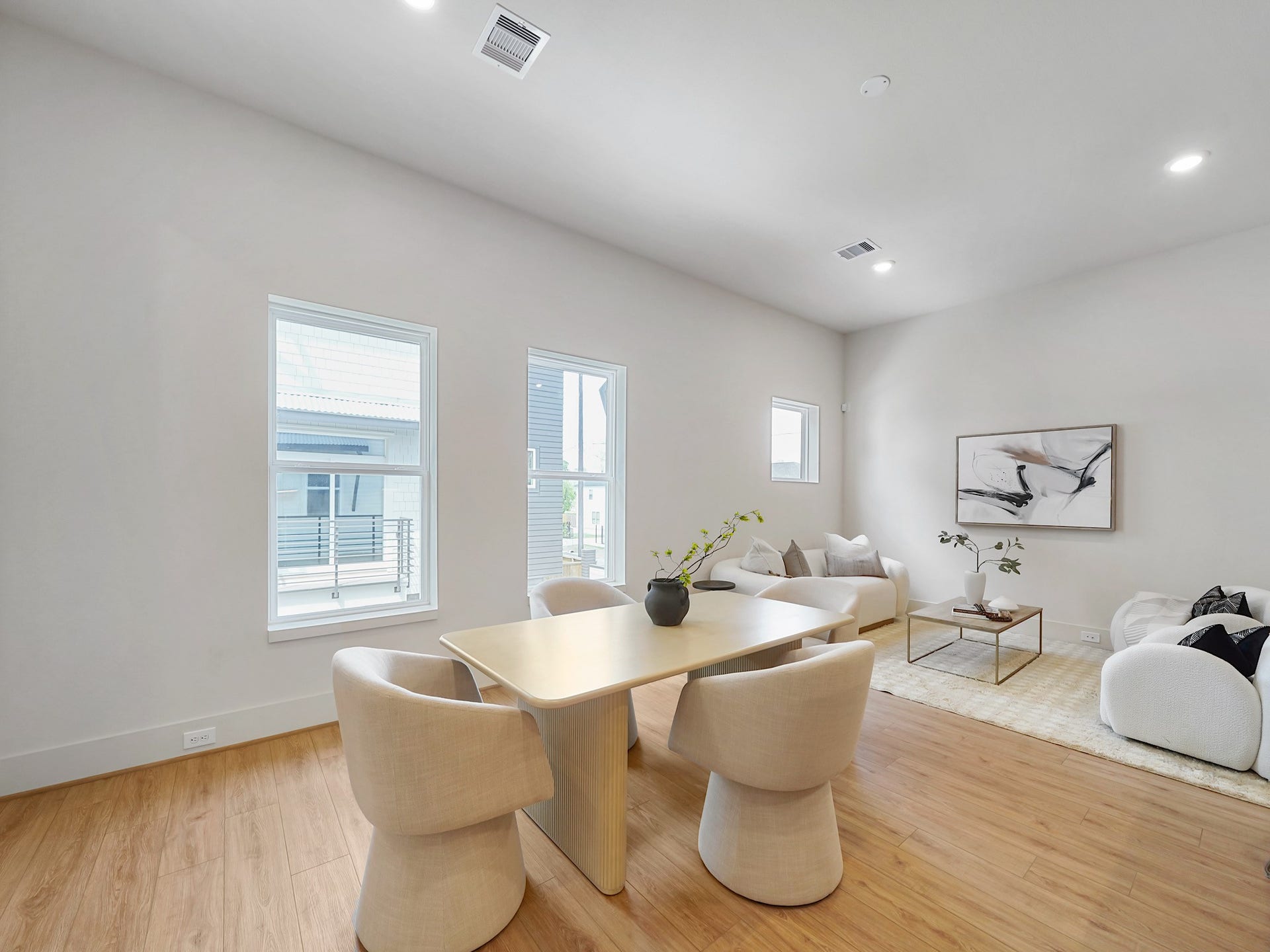 Discover seamless living with this inviting dining area, effortlessly blending into the open kitchen and cozy living space, perfect for entertaining and everyday comfort.