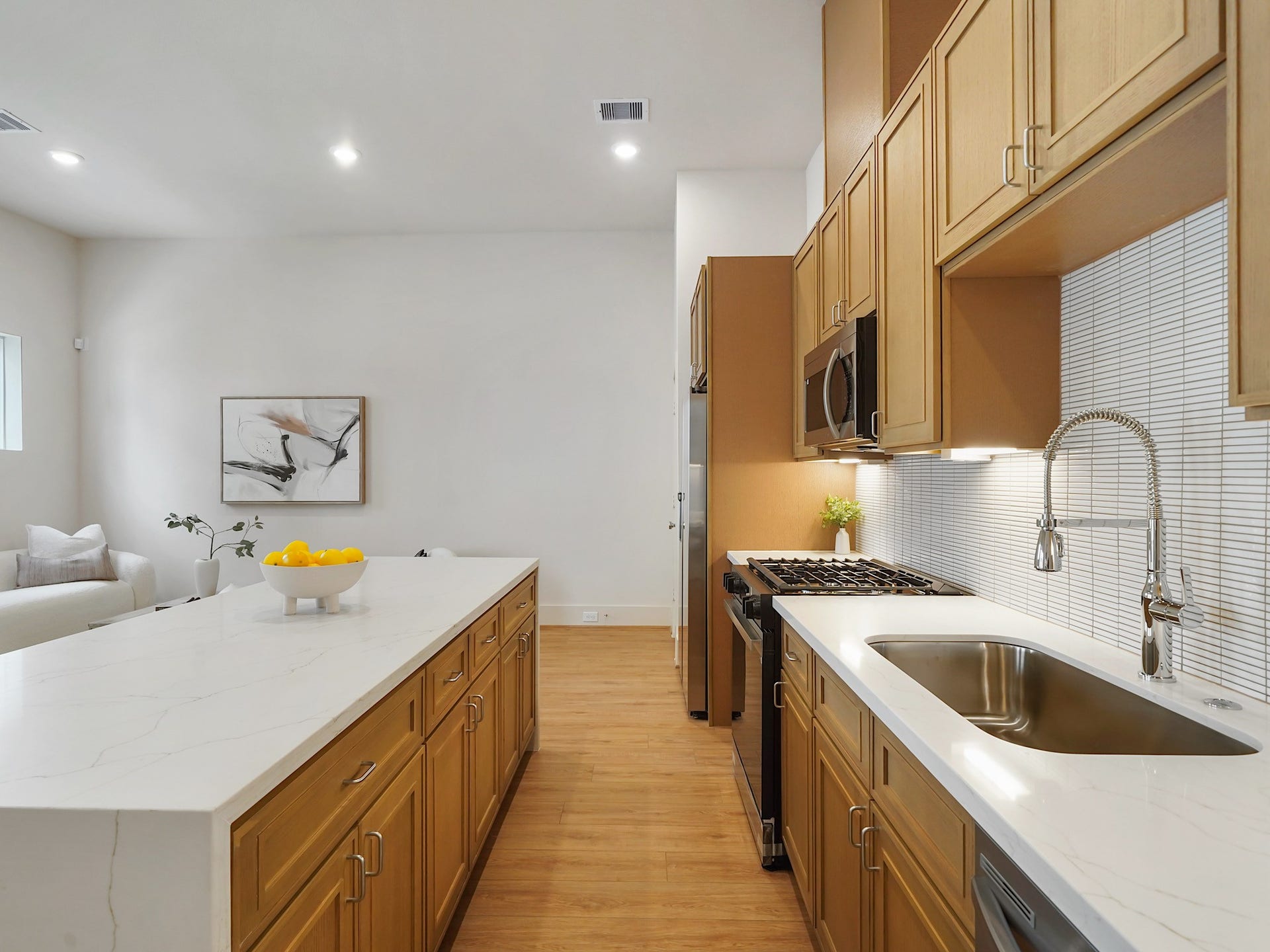 This sleek kitchen features stainless steel appliances and a stylish breakfast bar, making it perfect for entertaining.