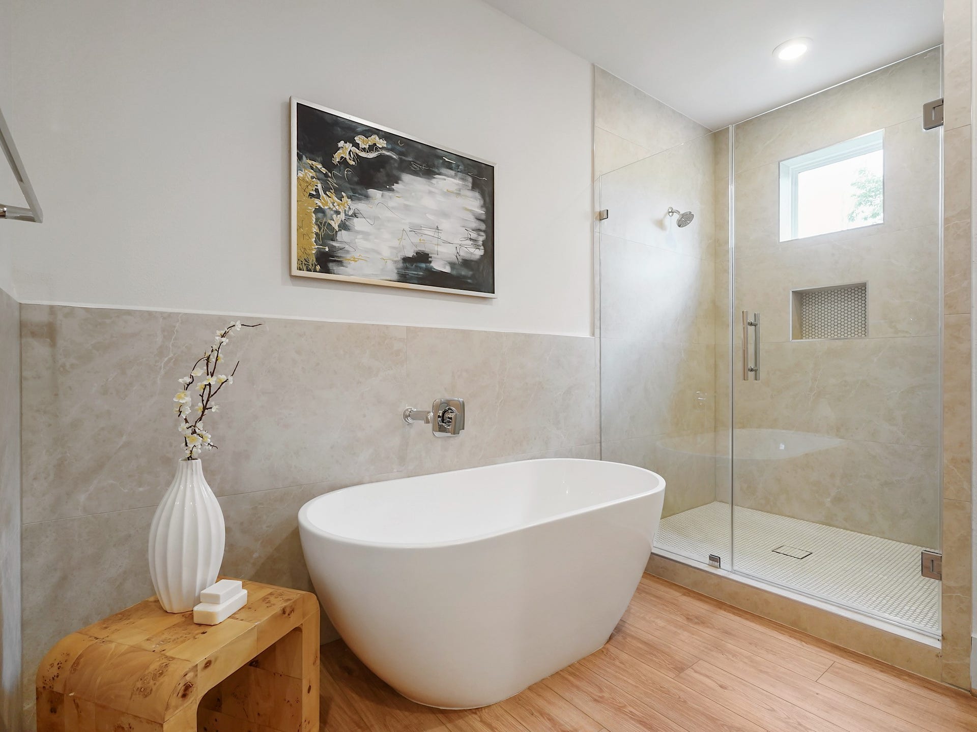 Experience pure tranquility in this sleek, stand-alone tub, offering a serene Zen ambiance for ultimate relaxation.