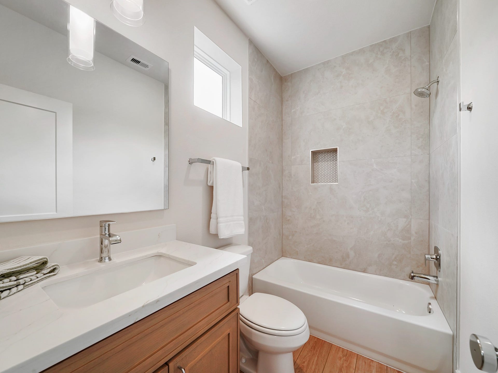 This elegant third bathroom features a sleek design with a spacious tub, modern fixtures, and a bright ambiance, perfect for enhancing your home's comfort and style.