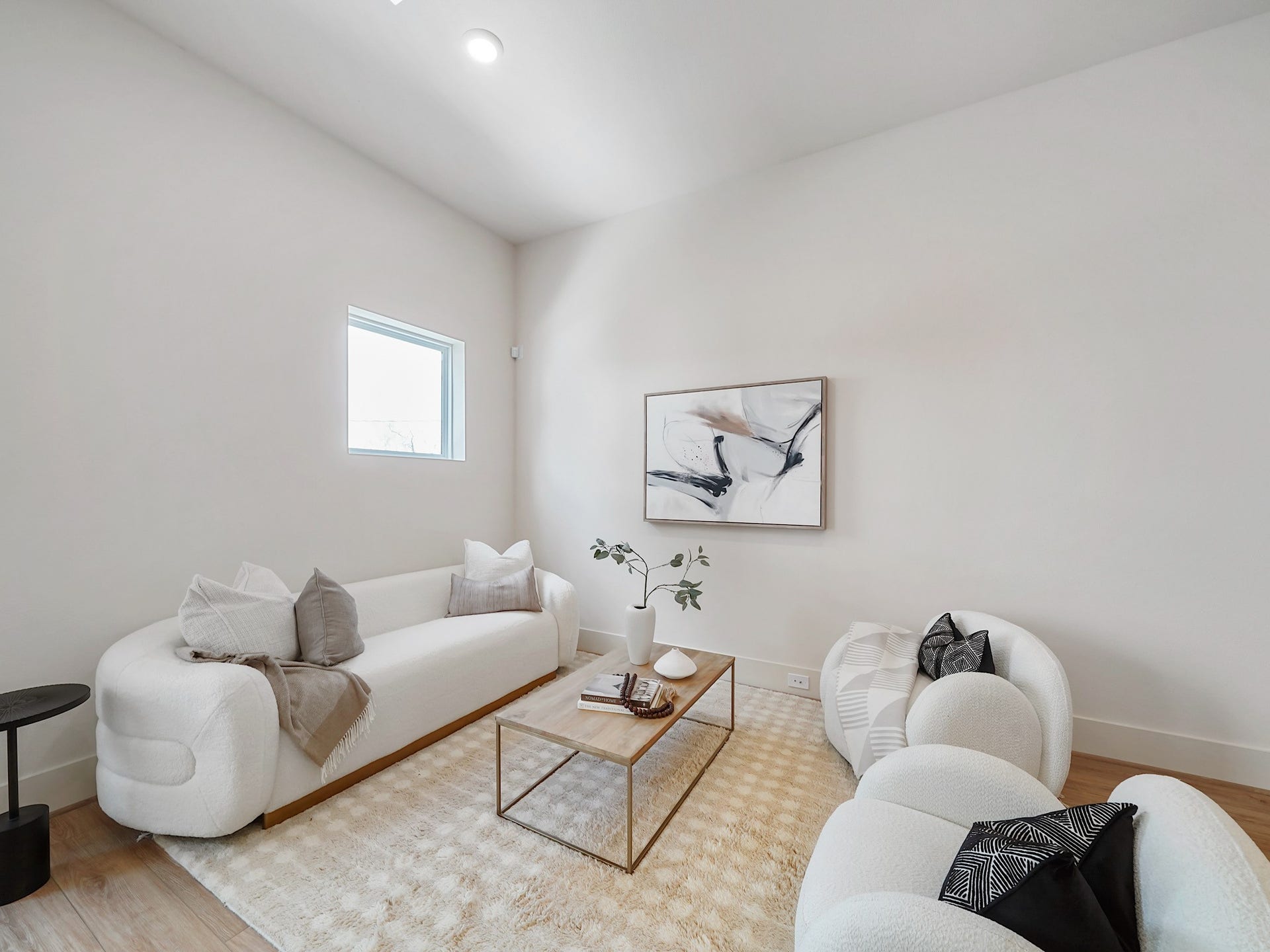 Discover a versatile flex space on the second level, elegantly designed with modern furnishings and abundant natural light, perfect for relaxing or working from home.