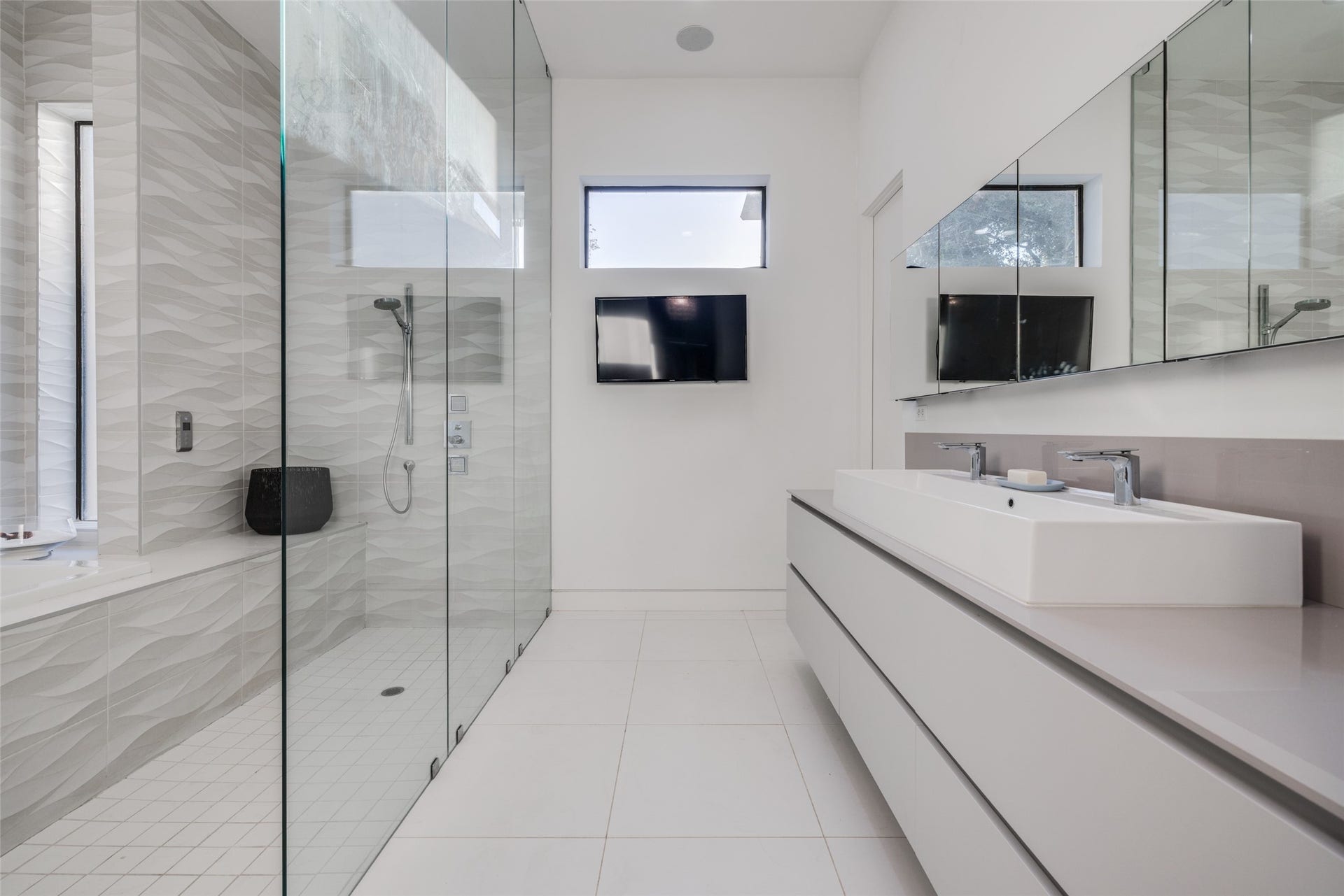 2014 Park Street, Houston, TX 77019 The gorgeous walk-in shower features designer stone tile, body sprayers, rainfall shower head, shower & soaking tub, lots of natural light, large sink with lots of drawer storage, heated floor, recently upgraded with Pedini cabinets