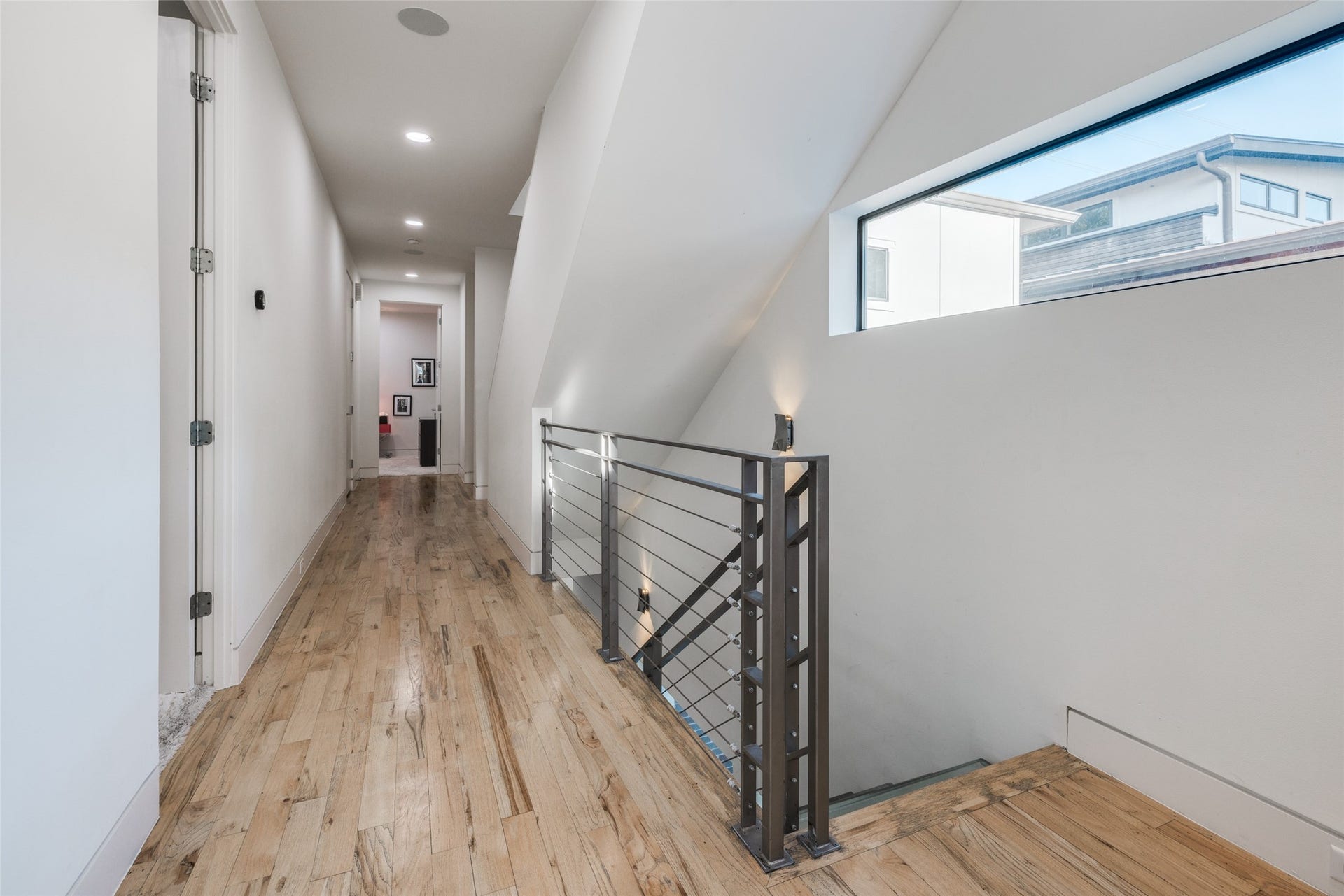 2014 Park Street, Houston, TX 77019 Second floor corridor leads to 3 bedrooms, including Primary Suite & utility room - warm hard wood floors - lots of natural light, downstairs has second office space.