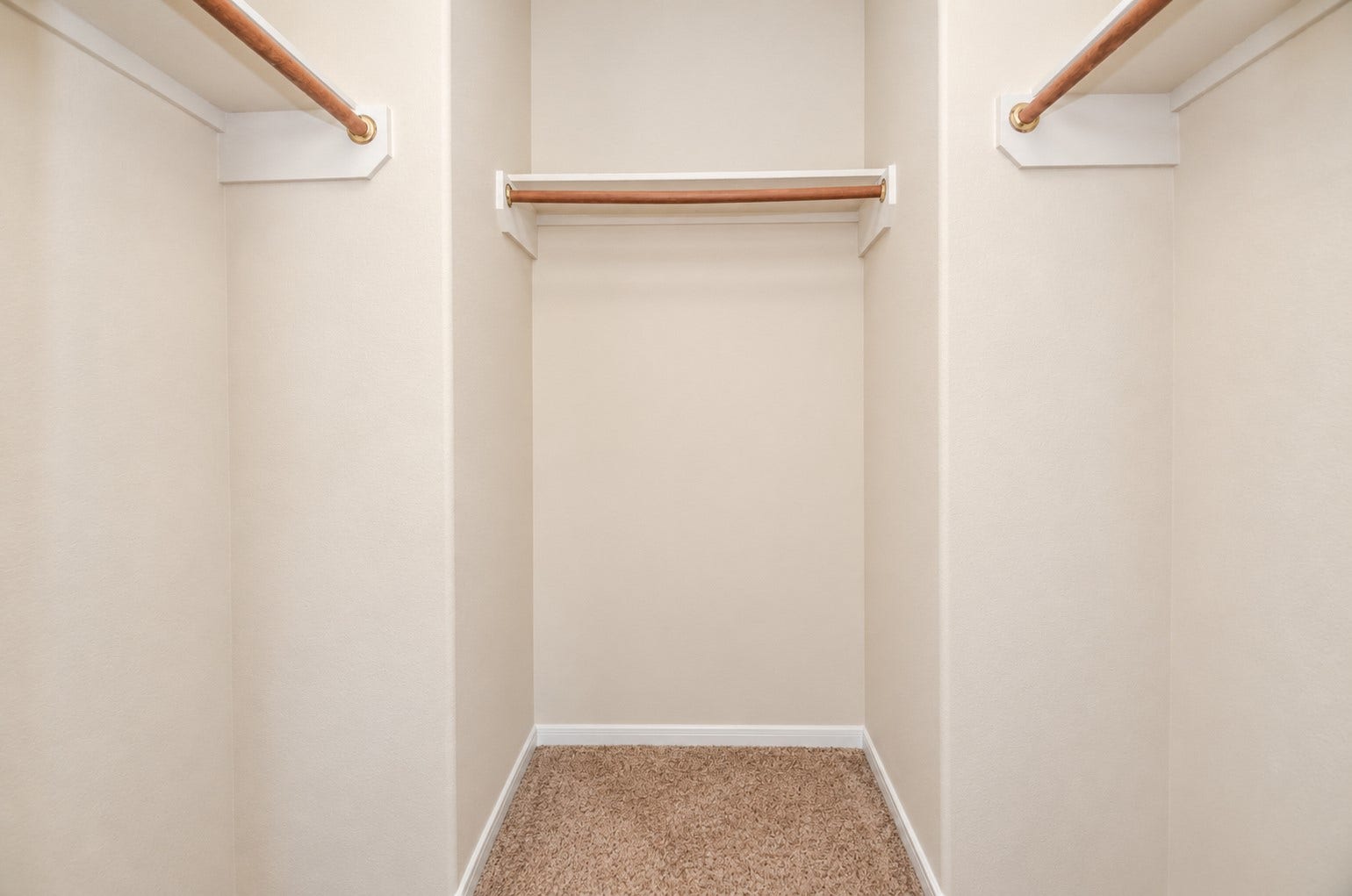 5031 Grove Square Court, Katy, TX 77449 Walk-in closet featuring multiple hanging rods and shelving, providing generous storage and organization options.