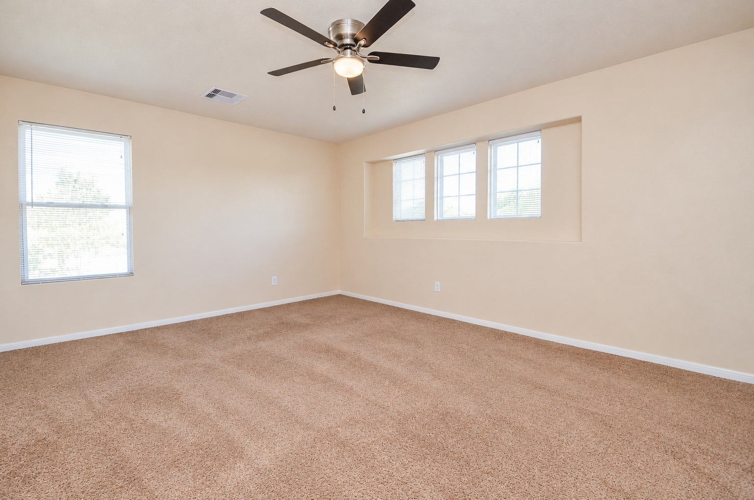 5031 Grove Square Court, Katy, TX 77449 Oversized second-floor bedroom featuring a ceiling fan, neutral carpeting and abundant natural light. Ideal as an optional second primary bedroom.