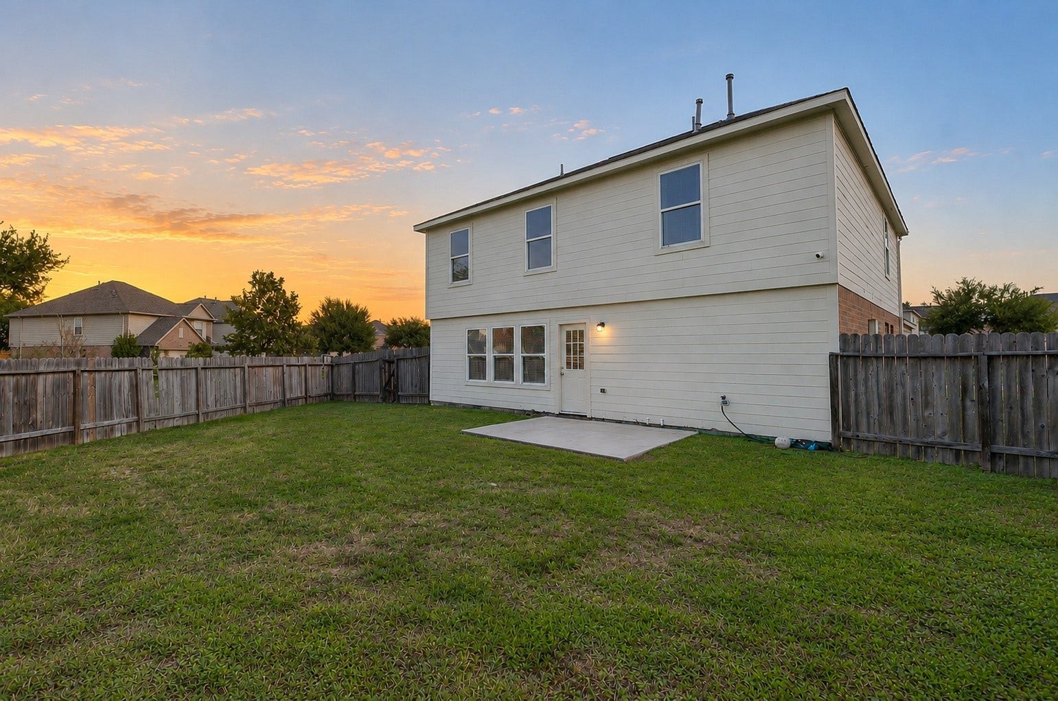 5031 Grove Square Court, Katy, TX 77449 Rear exterior view showcasing the home's two-story design, spacious fenced backyard and generous outdoor space.